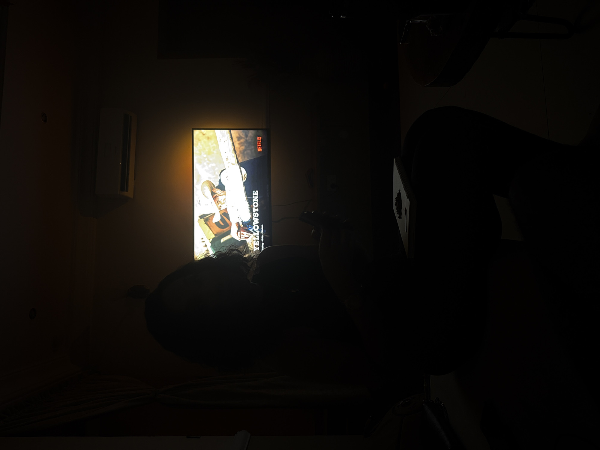 Evening Netflix viewing captured in dimly lit Ojomu home