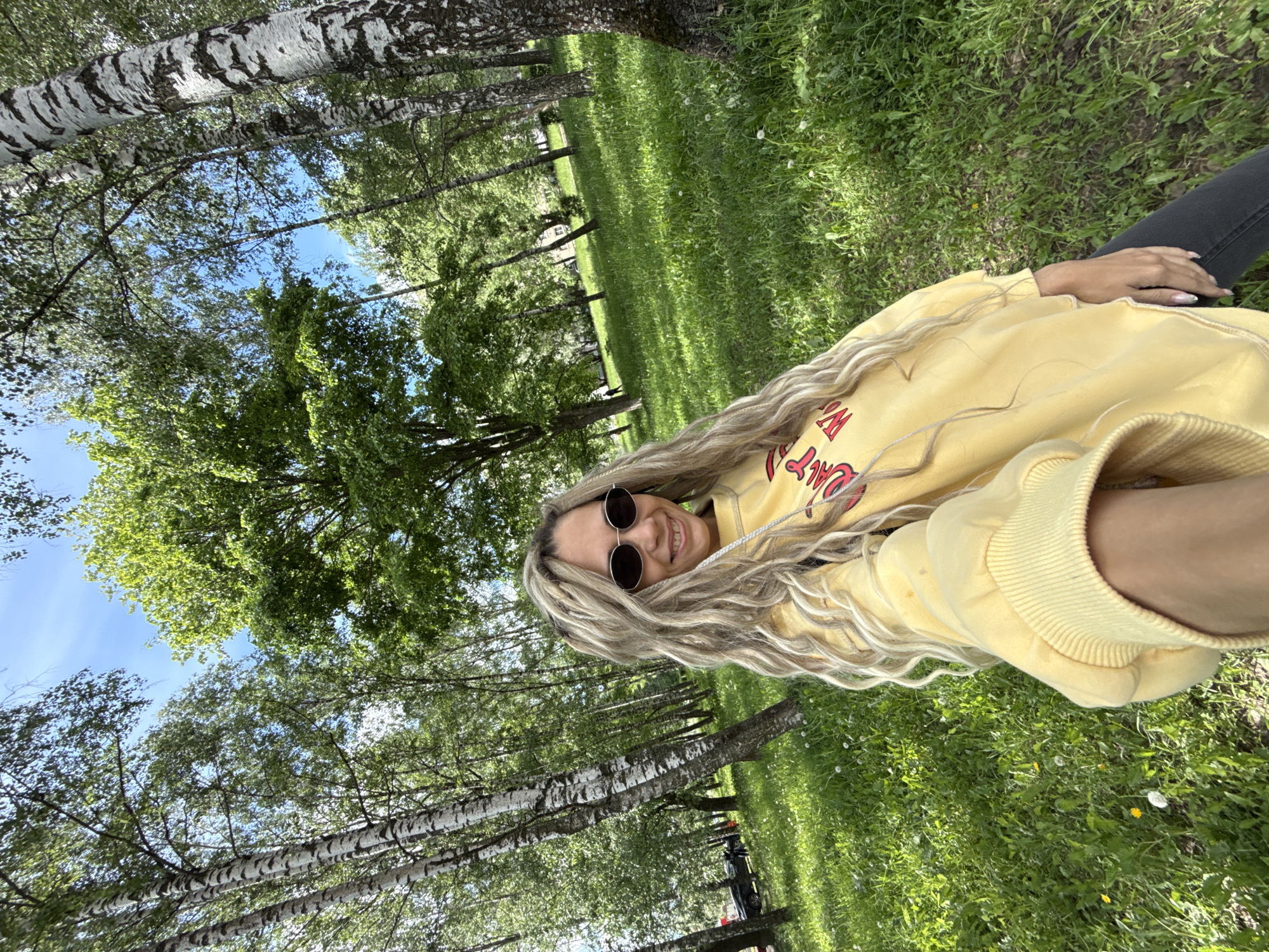 Person resting in birch grove near Rusanovo, Russia