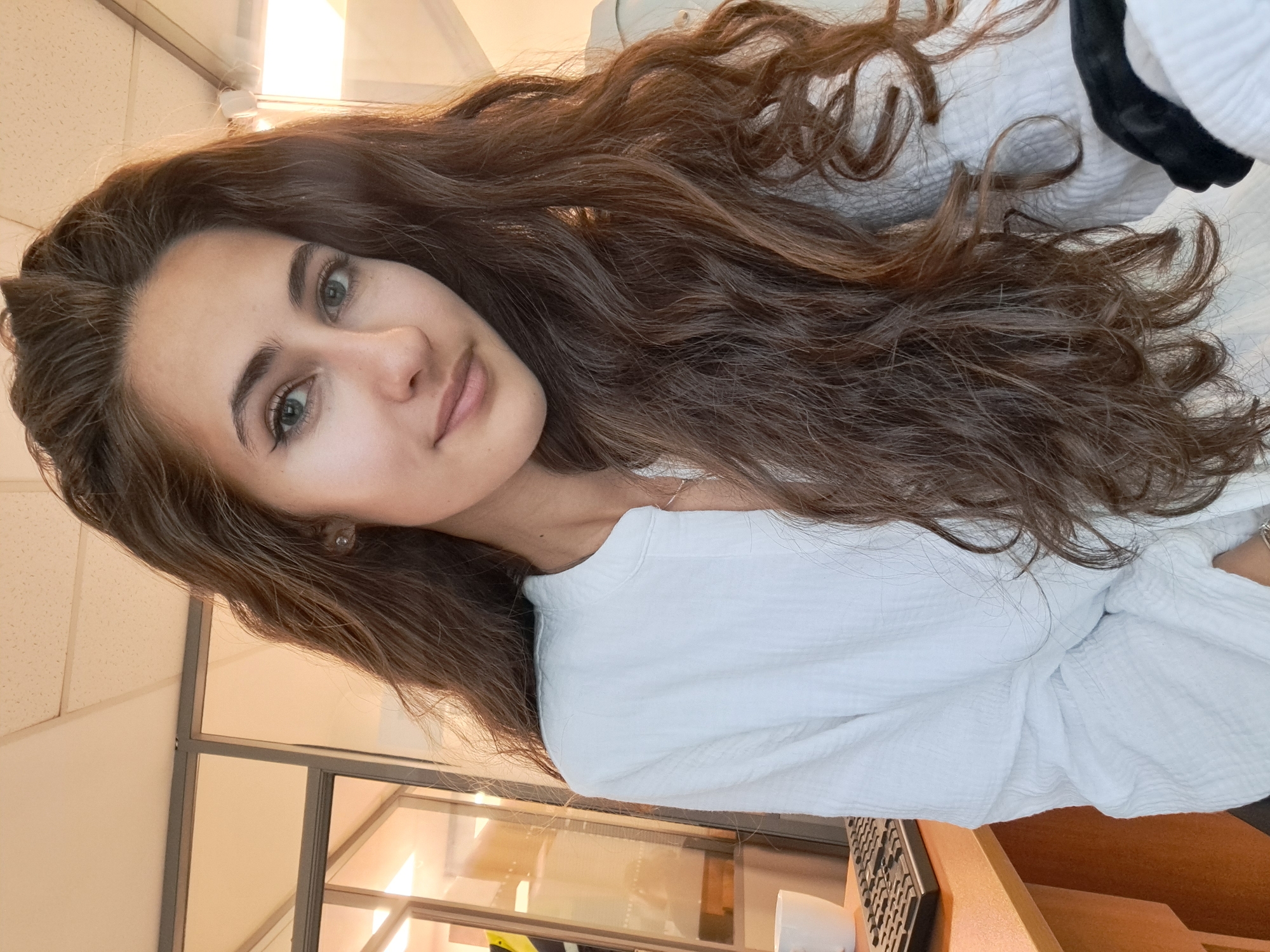 Woman poses playfully in Sofia office setting