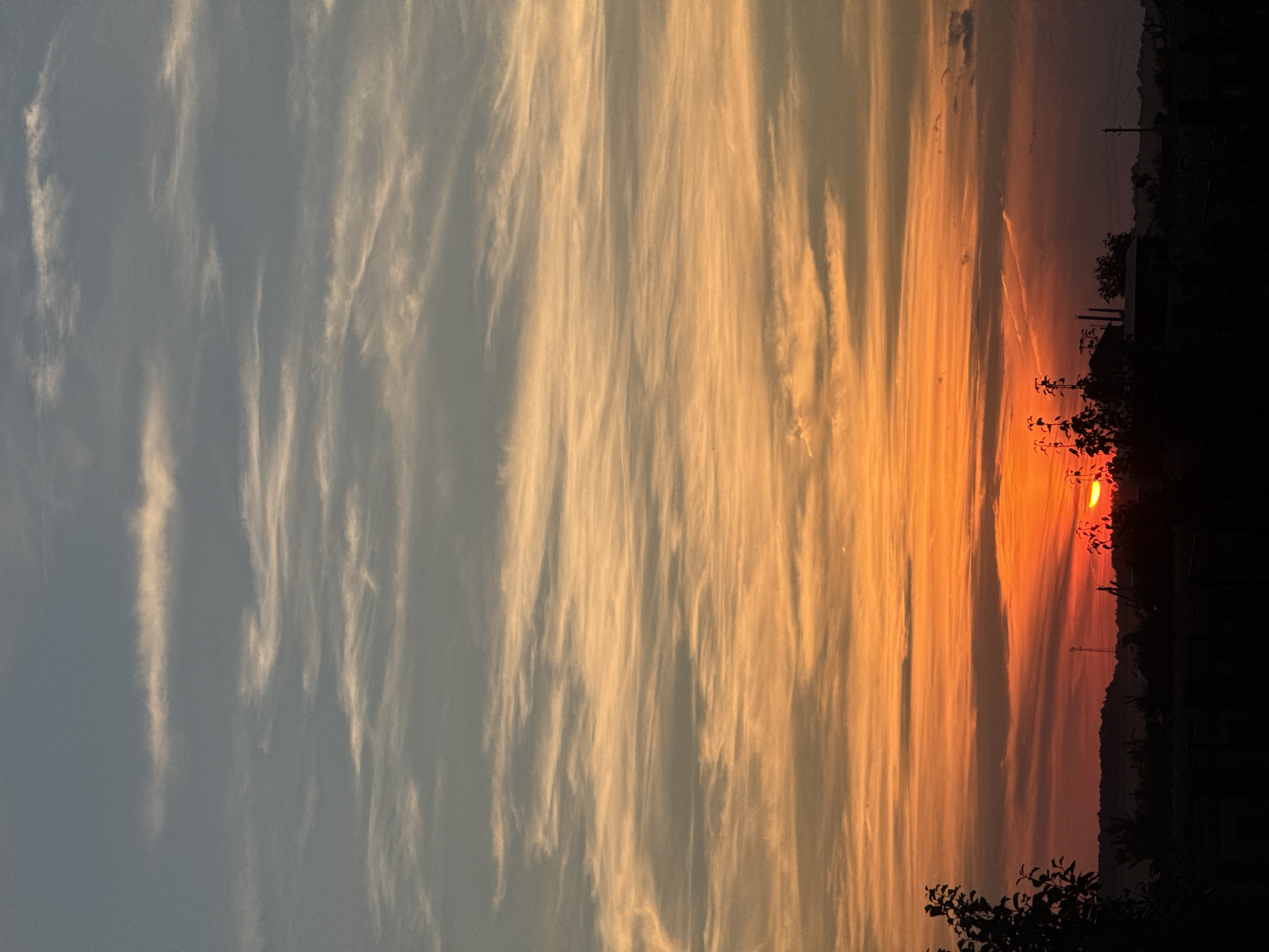 Rural sunset over a fenced field, vivid colors at dusk