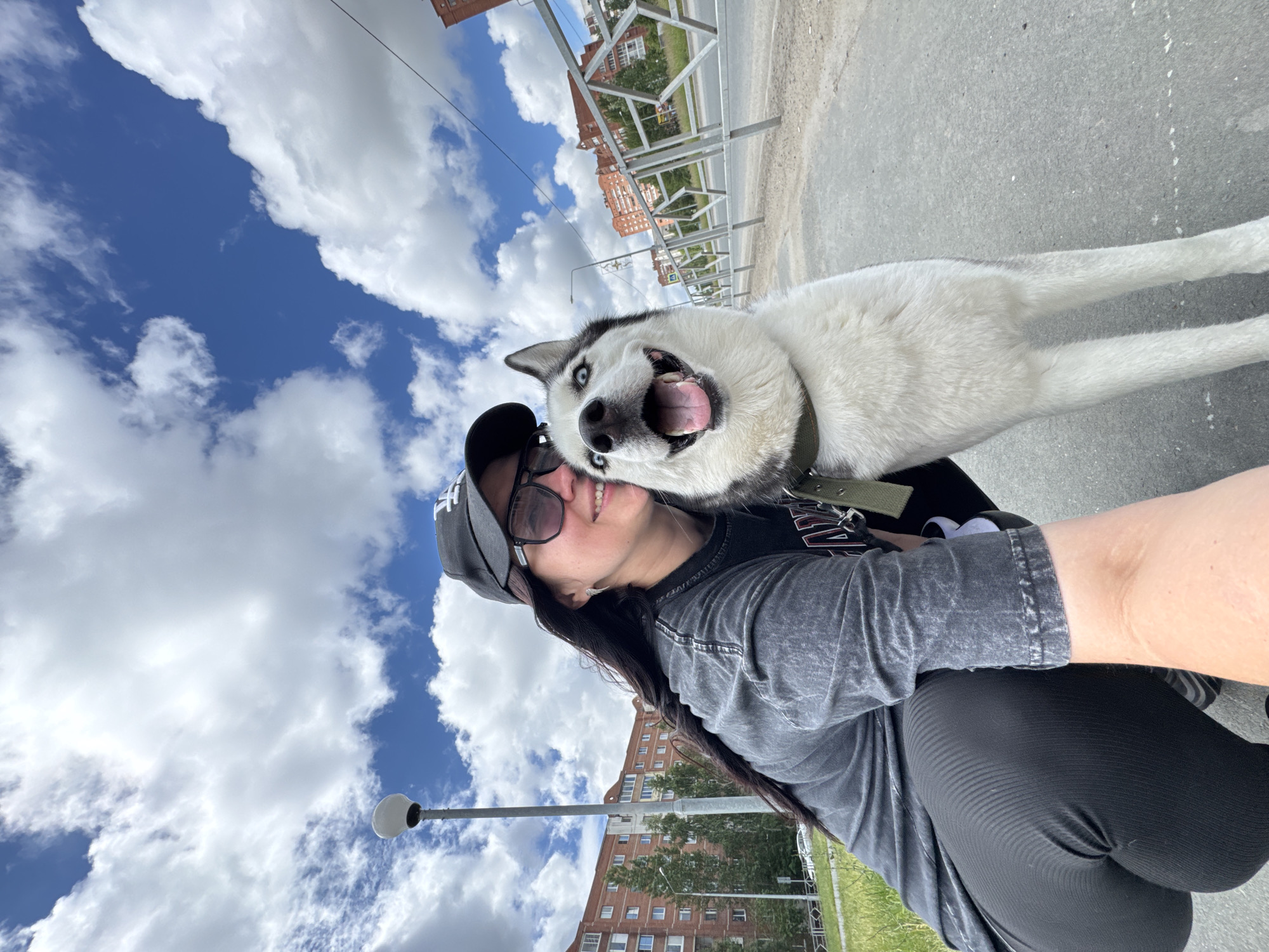Woman documents morning walk with Husky in outdoor selfie series