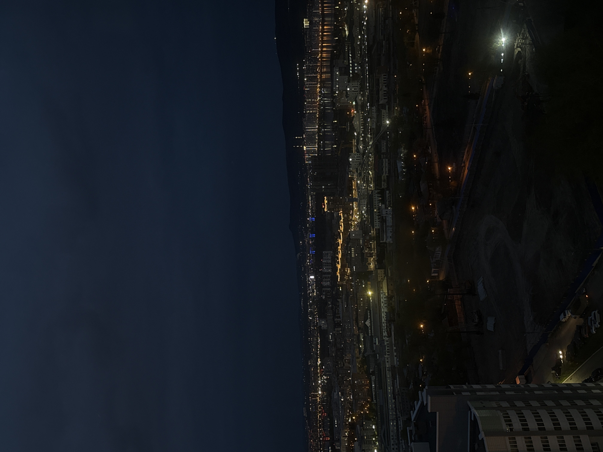 Nighttime cityscape views captured from indoor window in Krasnoyarsk