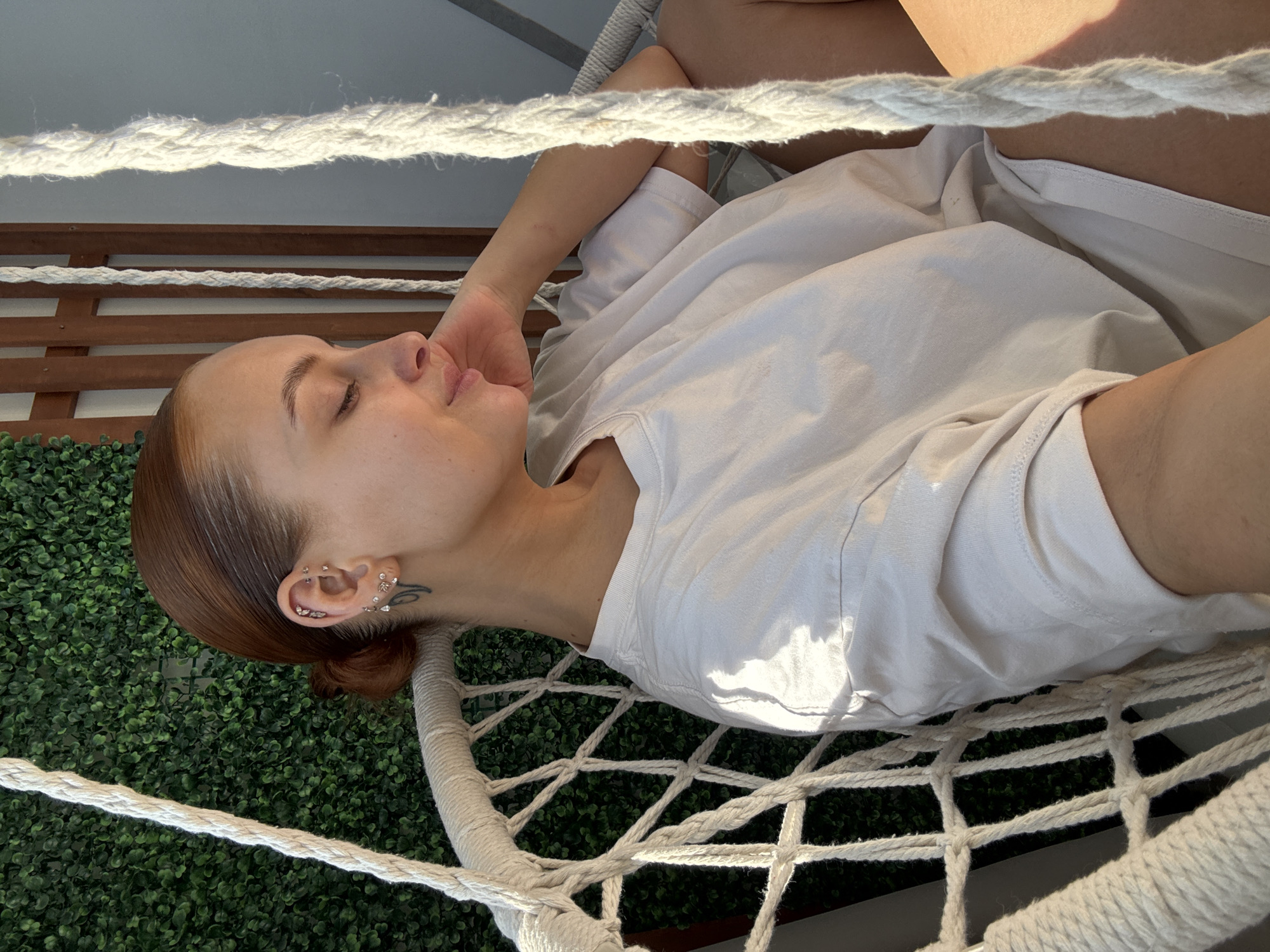 Woman enjoys quiet morning moments in hammock in Chaikovsky
