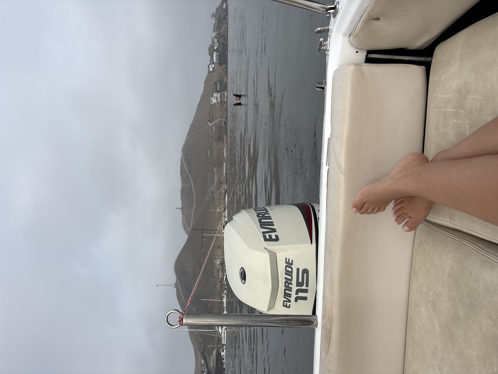Person relaxes on boat in Ancón Bay, Peru