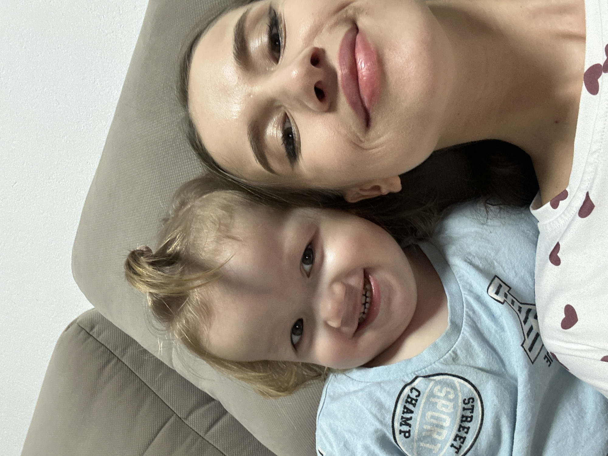 Mother and child share quiet moment on couch in Yekaterinburg