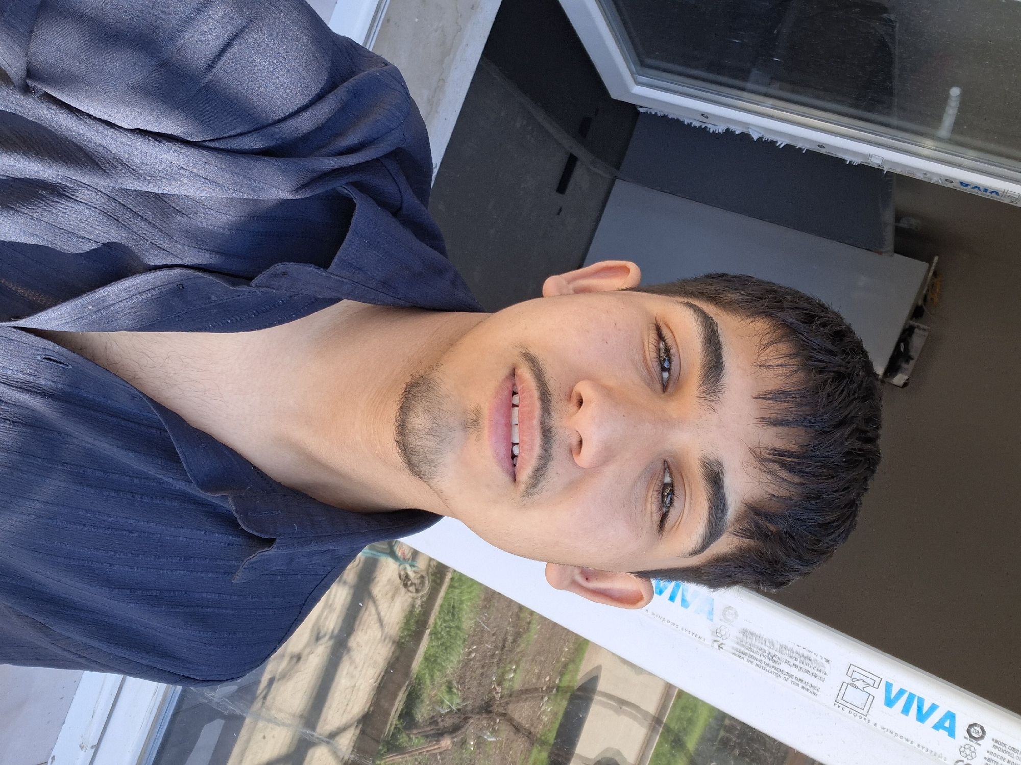 Young man takes selfie video outside business in Bulgaria
