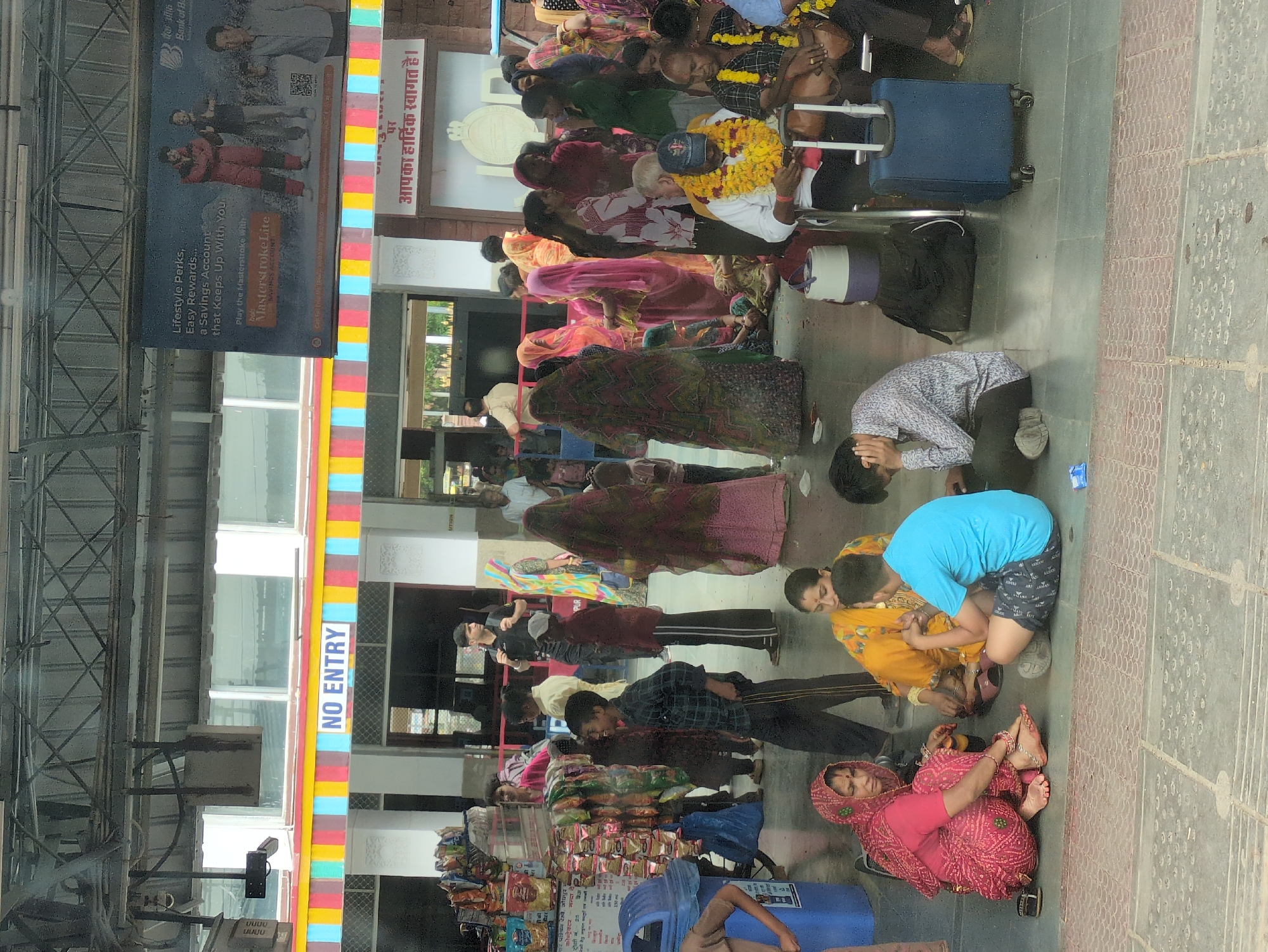 Police officer escorts person through Jodhpur Junction platform