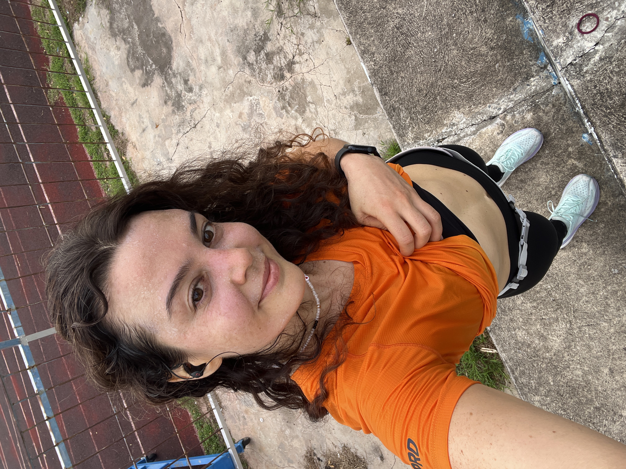 Post-run selfies on a Phan Thiết track, church in the background