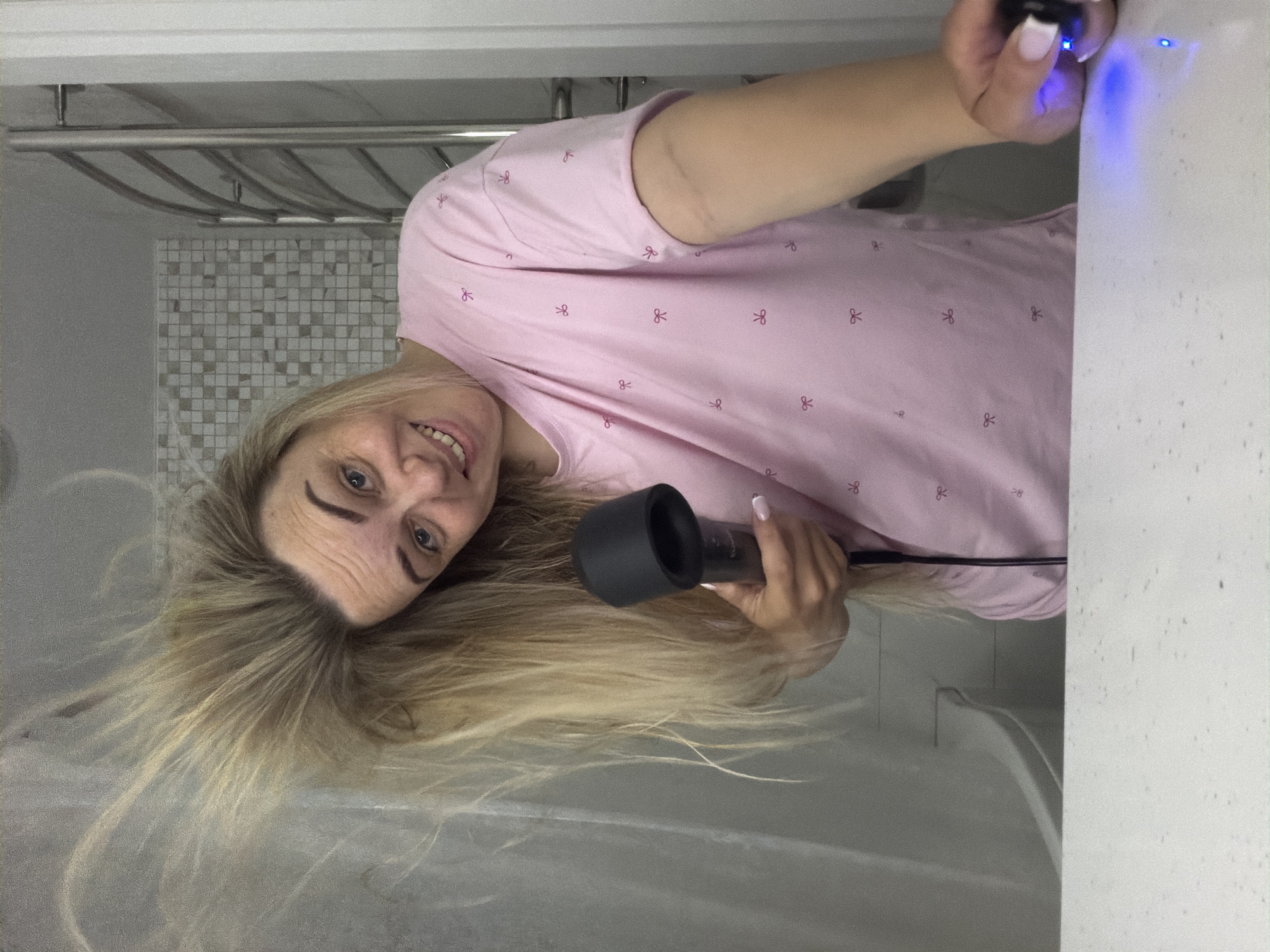 Woman's evening hair routine documented in Votkinsk bathroom