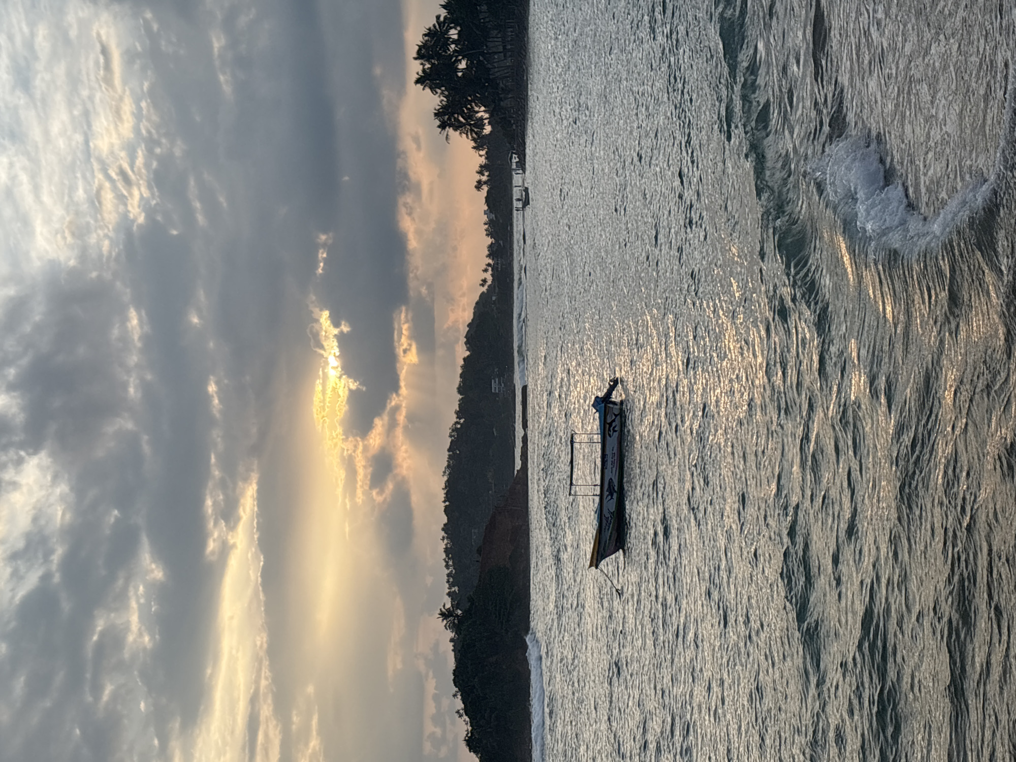 Sunset beach scene with child, dog captured in Thalaramba, Sri Lanka