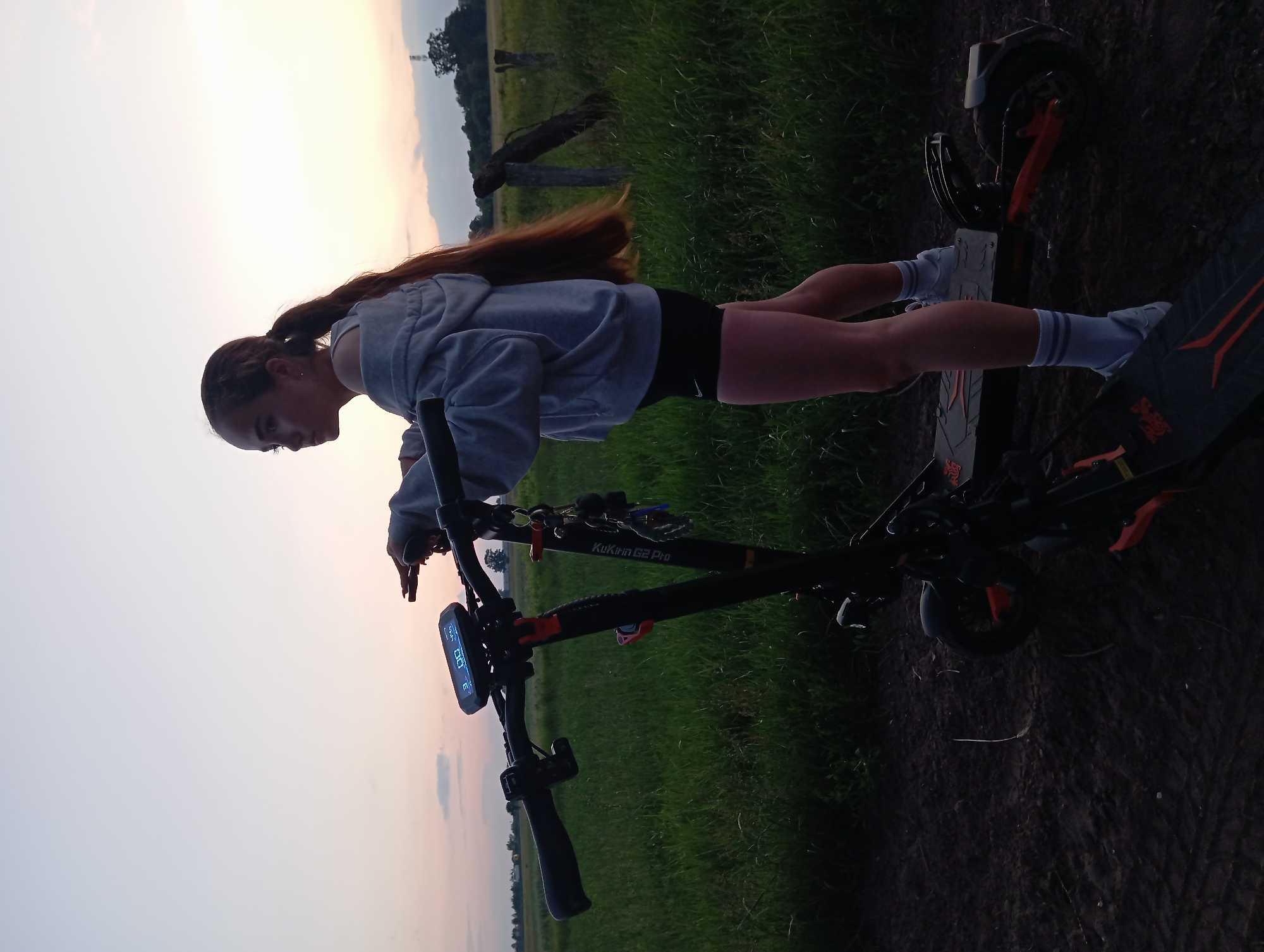 Evening scooter stop in Polish countryside, wildflowers in hand