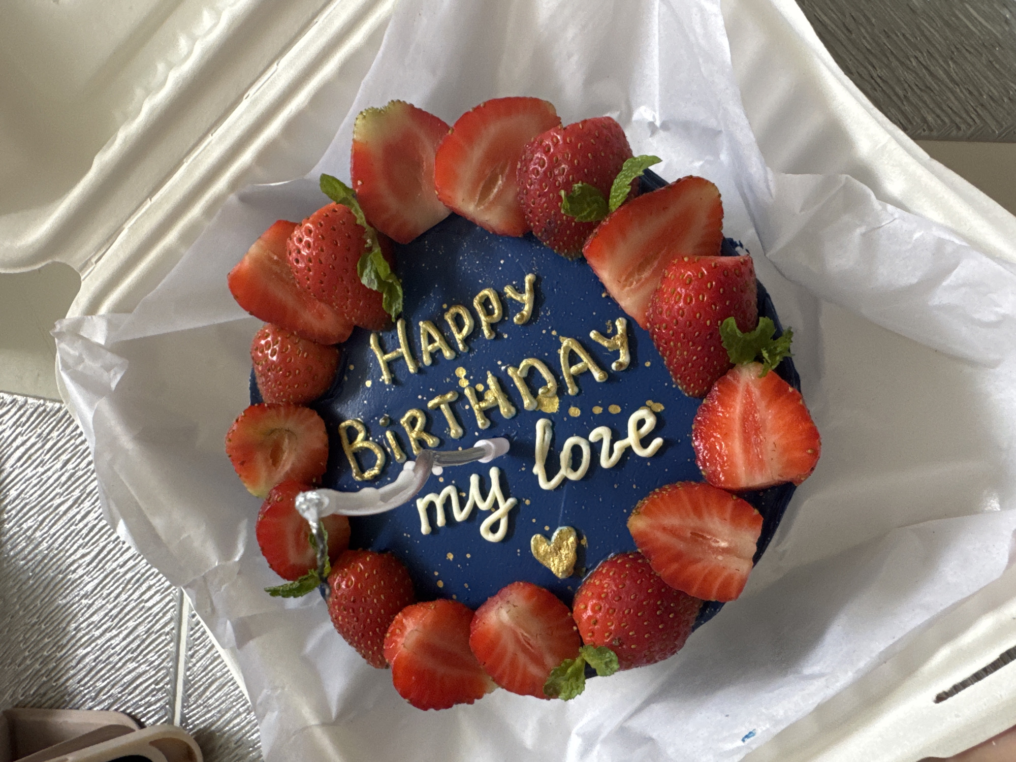 Birthday cake with personalized message observed in takeout container