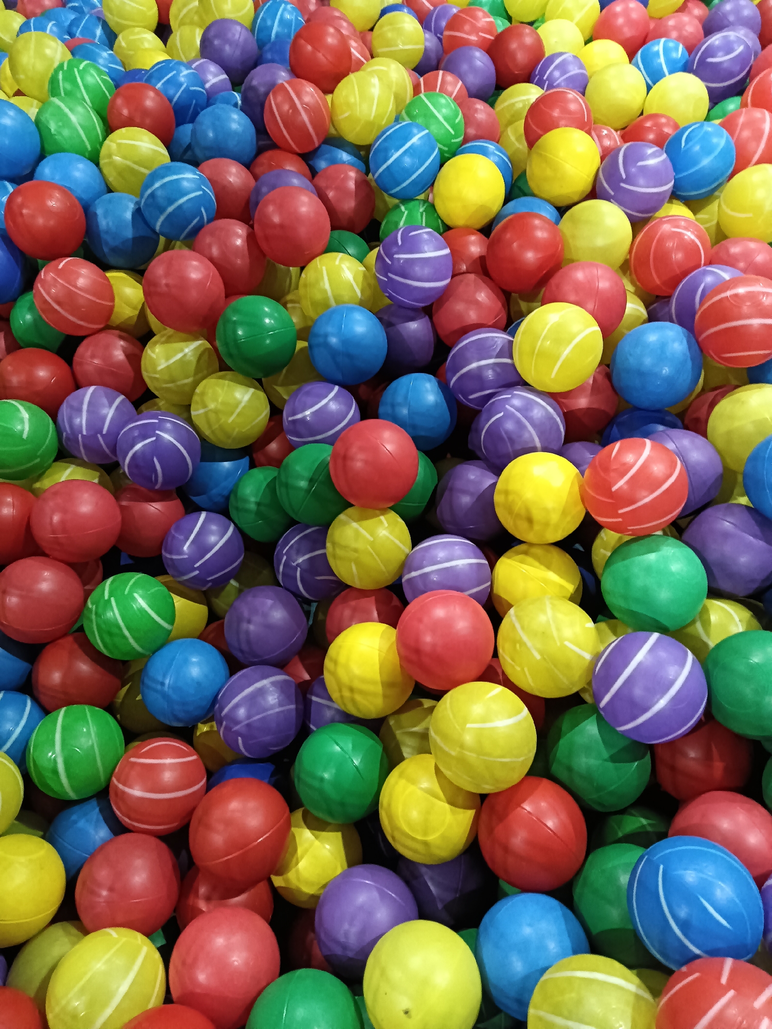 Indoor playground facility with ball pits and games documented