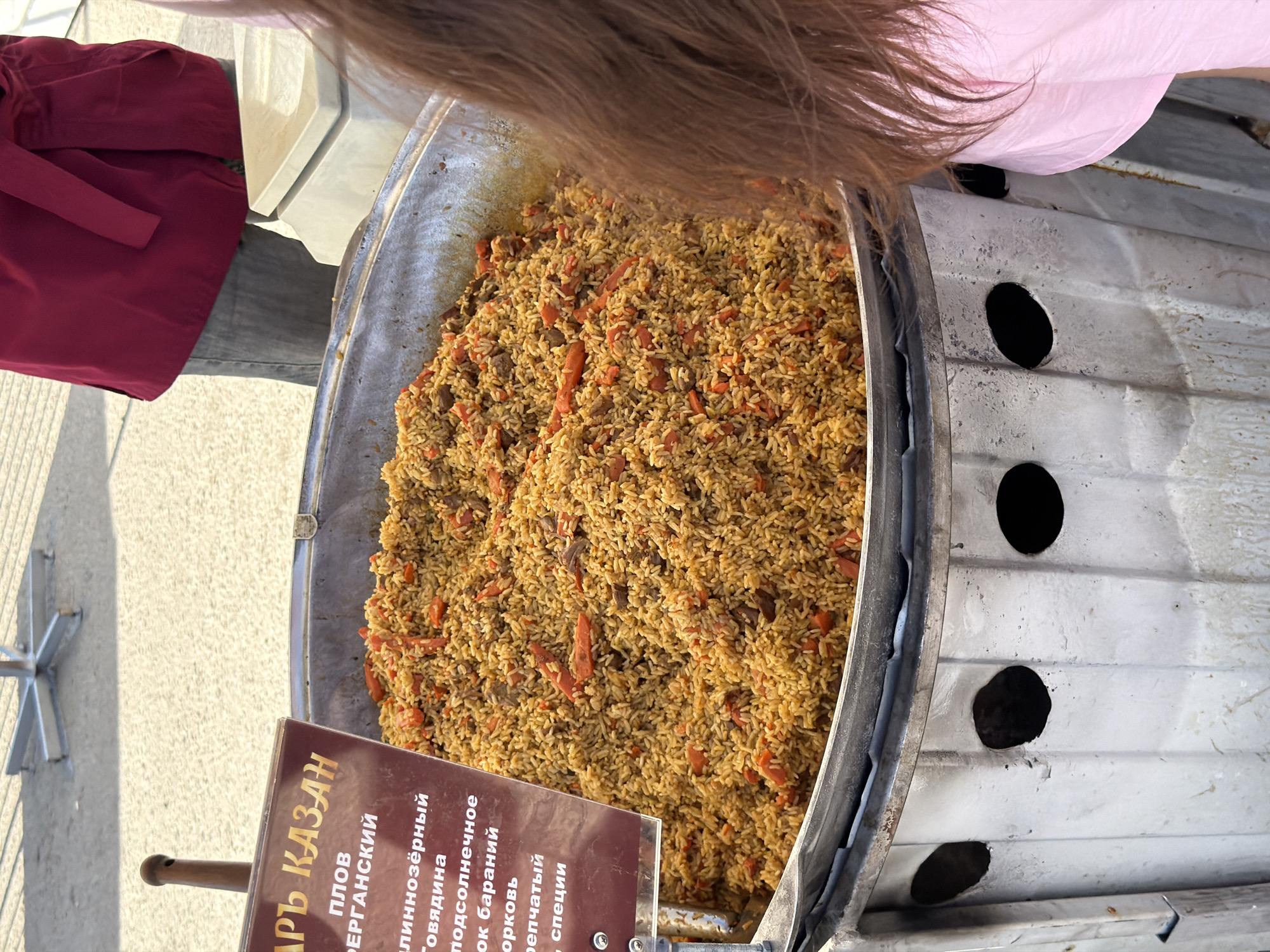 Food market bustling in Samara as vendors serve plov