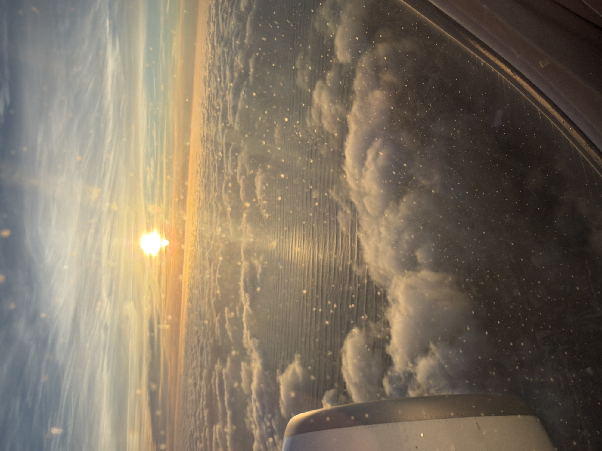 Passenger photographs sunset clouds from airplane over Portugal