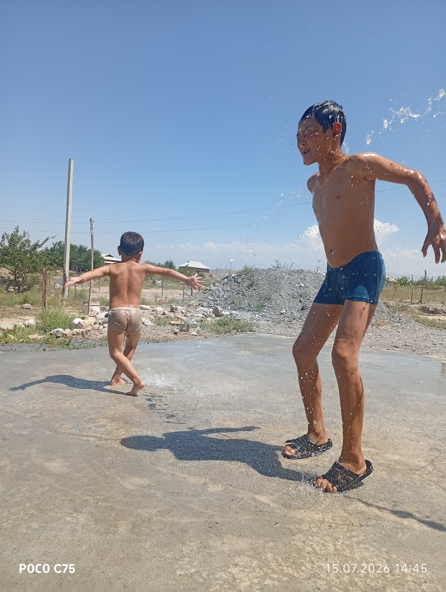 Kids playing in water on a sunny day in Kyrgyzstan