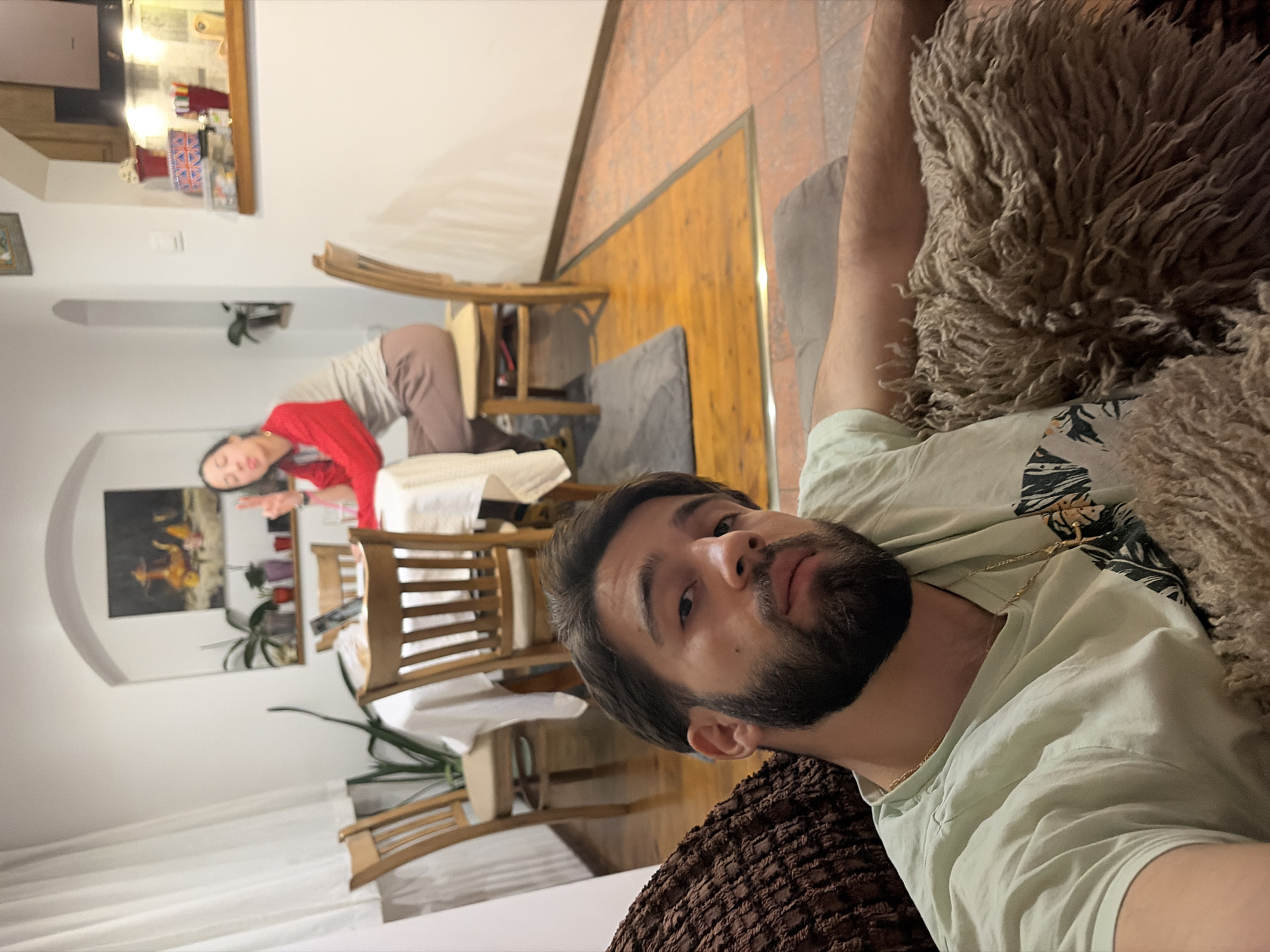 Two people relax indoors in Sofia evening setting