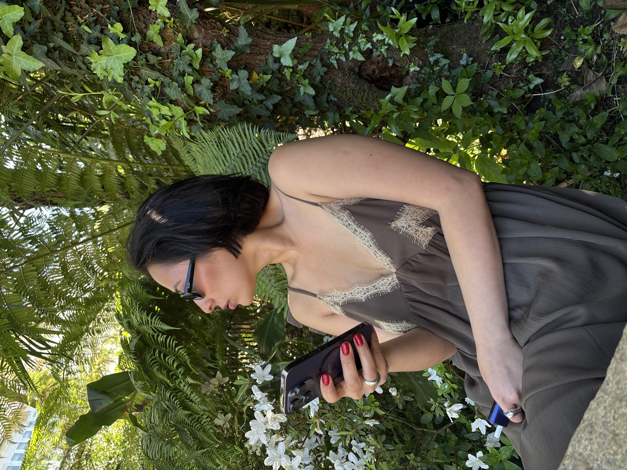 Woman enjoys outdoor refreshments in Santiago de Compostela garden
