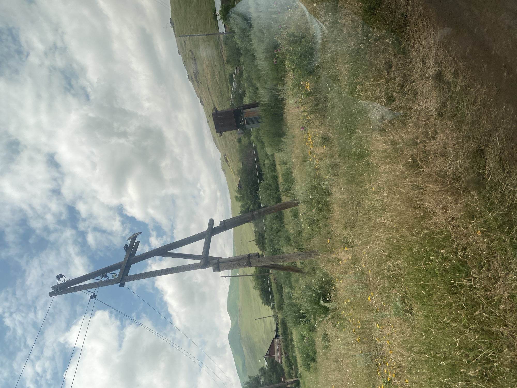 Morning drive through green hills, wildflowers, and a rural stone church