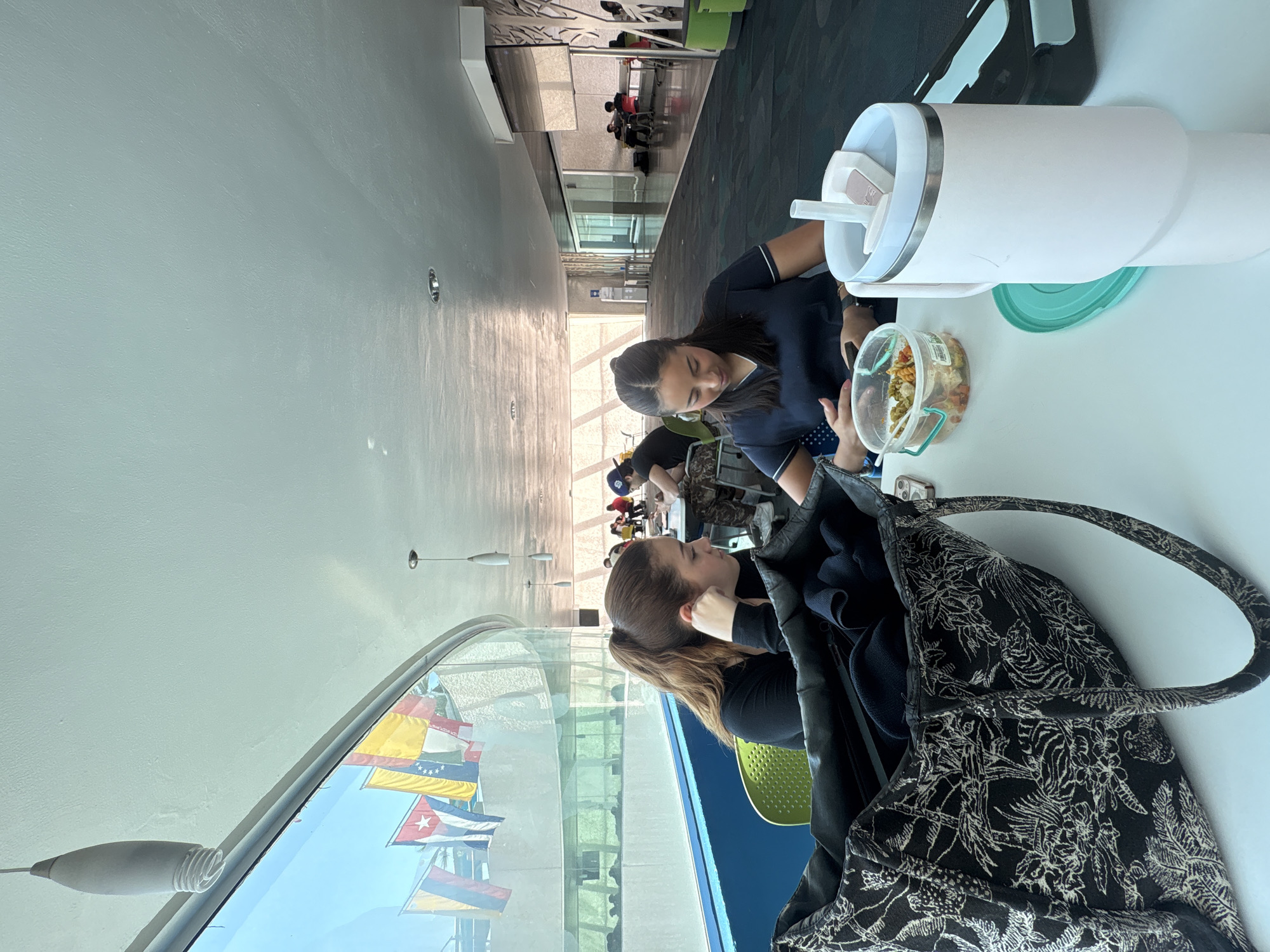 Two women dine at modern cafeteria in Puebla