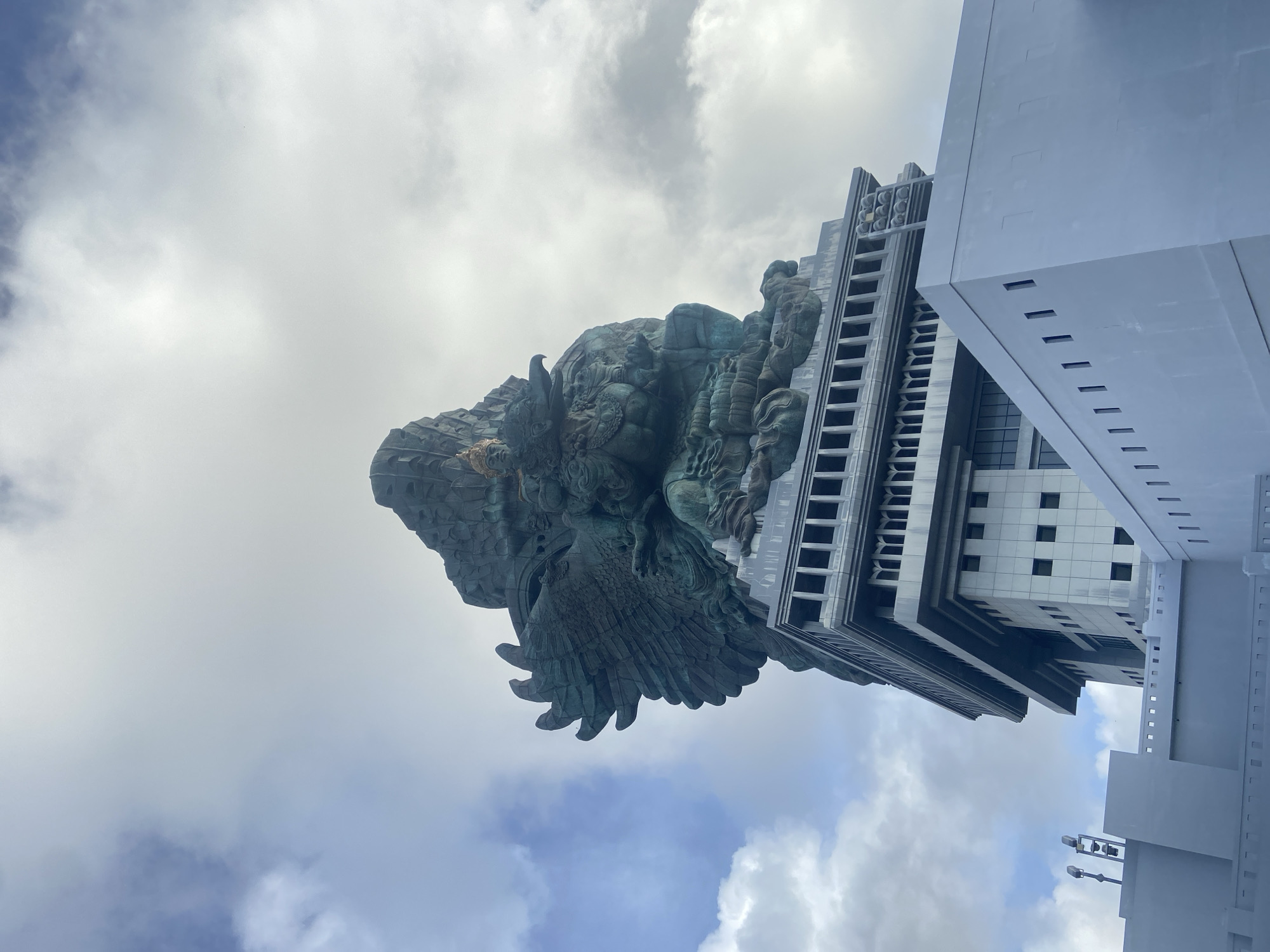 Tourist captures low-angle view of Garuda Wisnu Kencana statue