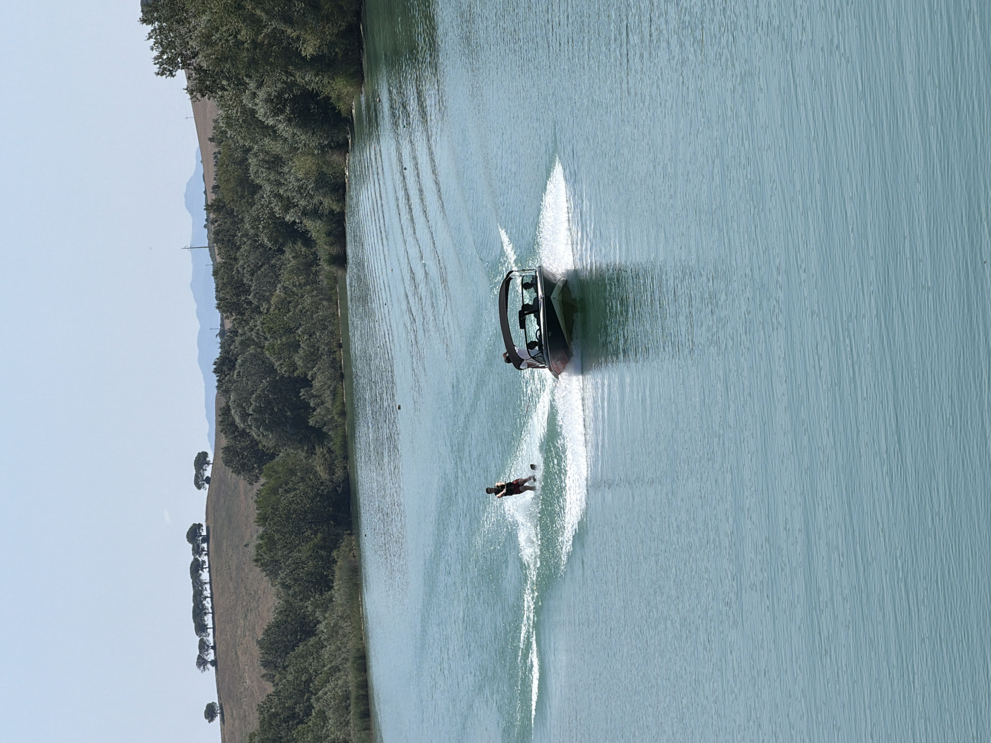 Water sports and a playful dog at a sunny Rome lakeside