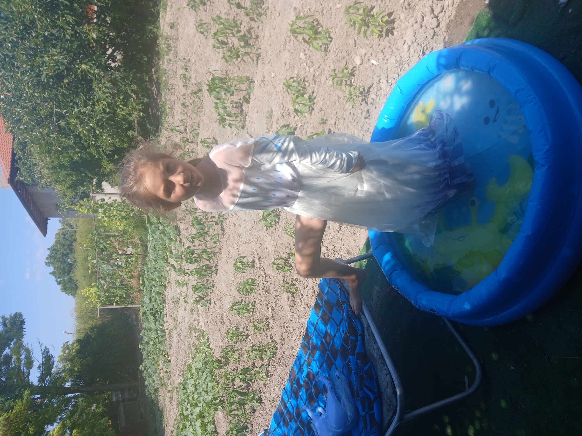 Backyard kiddie pool day in a Bulgarian garden