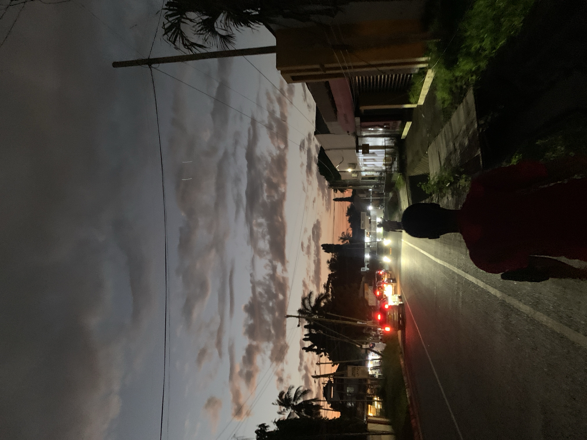 Dusk settles over a Dar es Salaam street and fruit stand