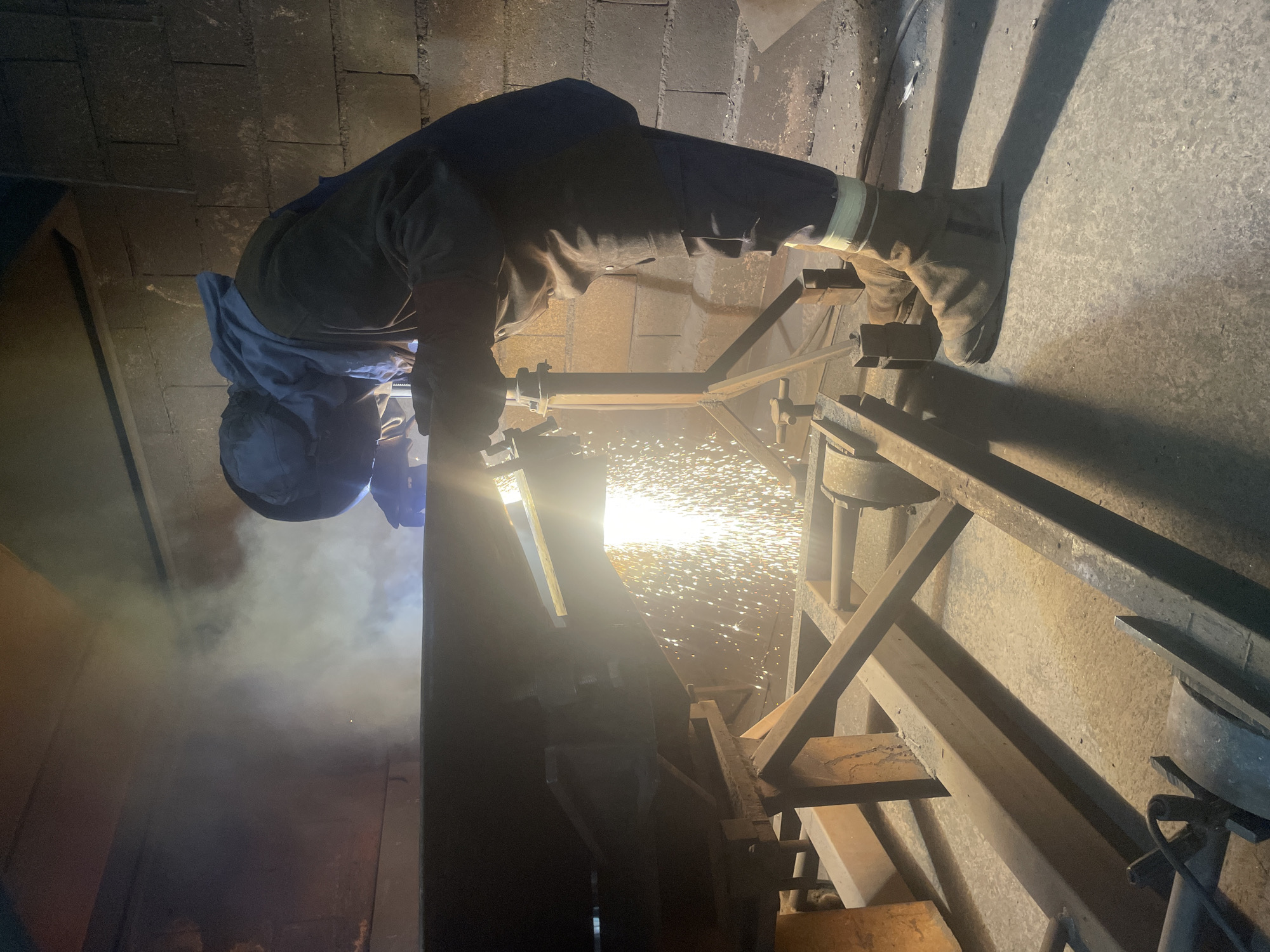 Welder performs metal work in Montenegro industrial workshop