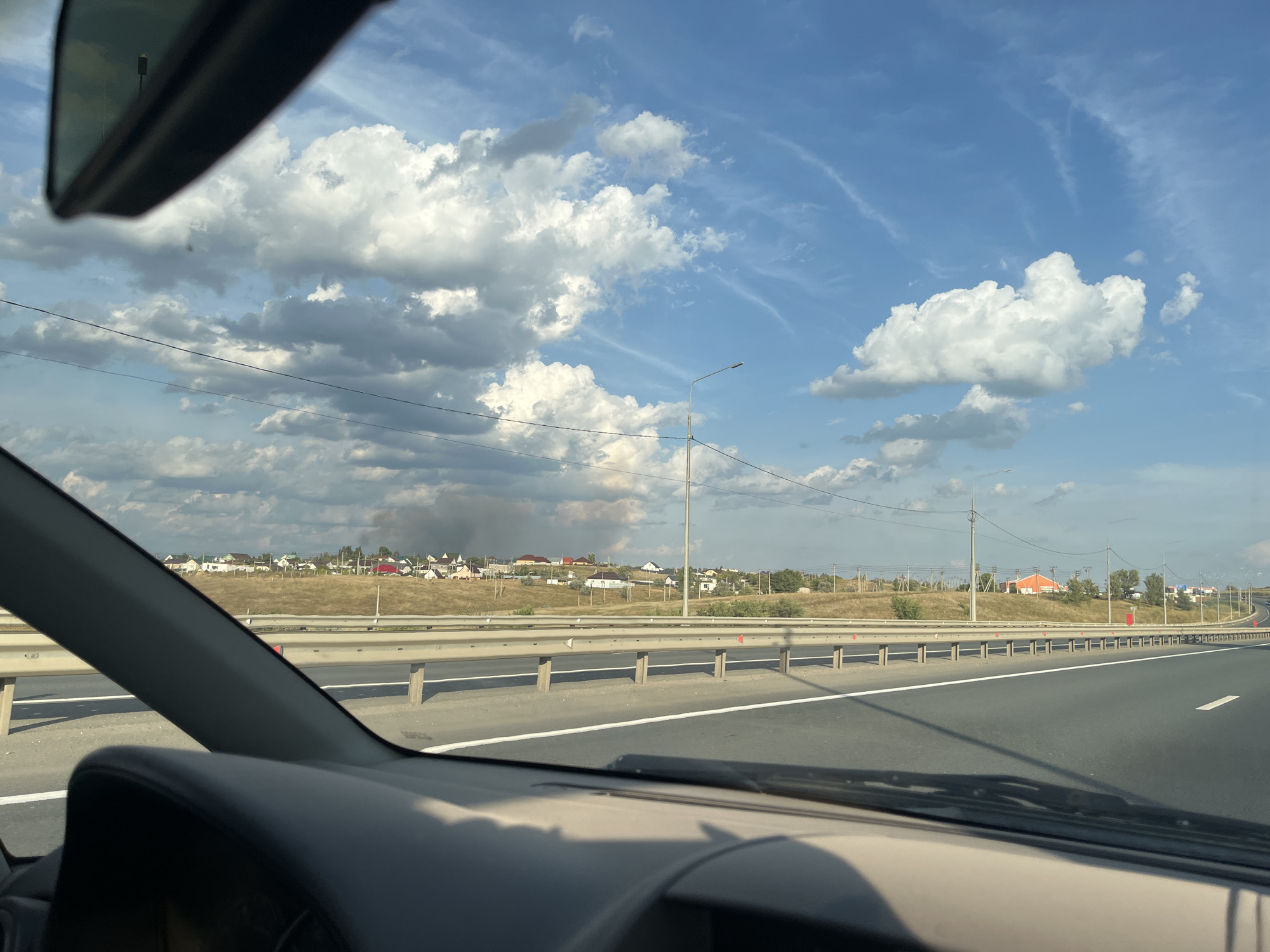 Highway drive past a rural Russian settlement near Dubki