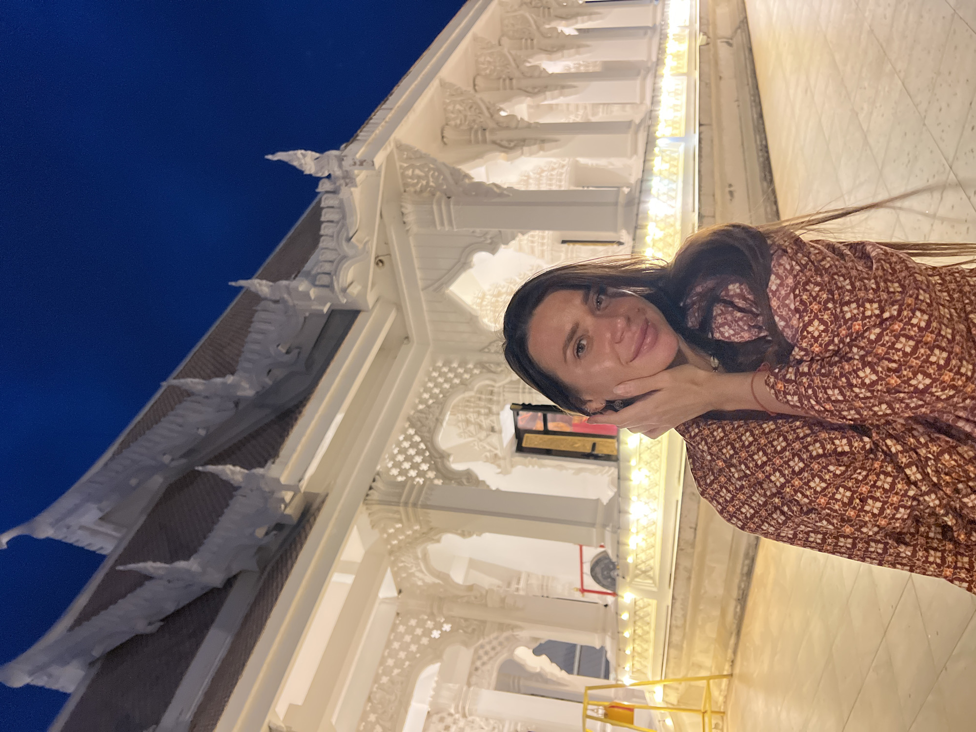 Tourist poses for photos at Thai temple complex