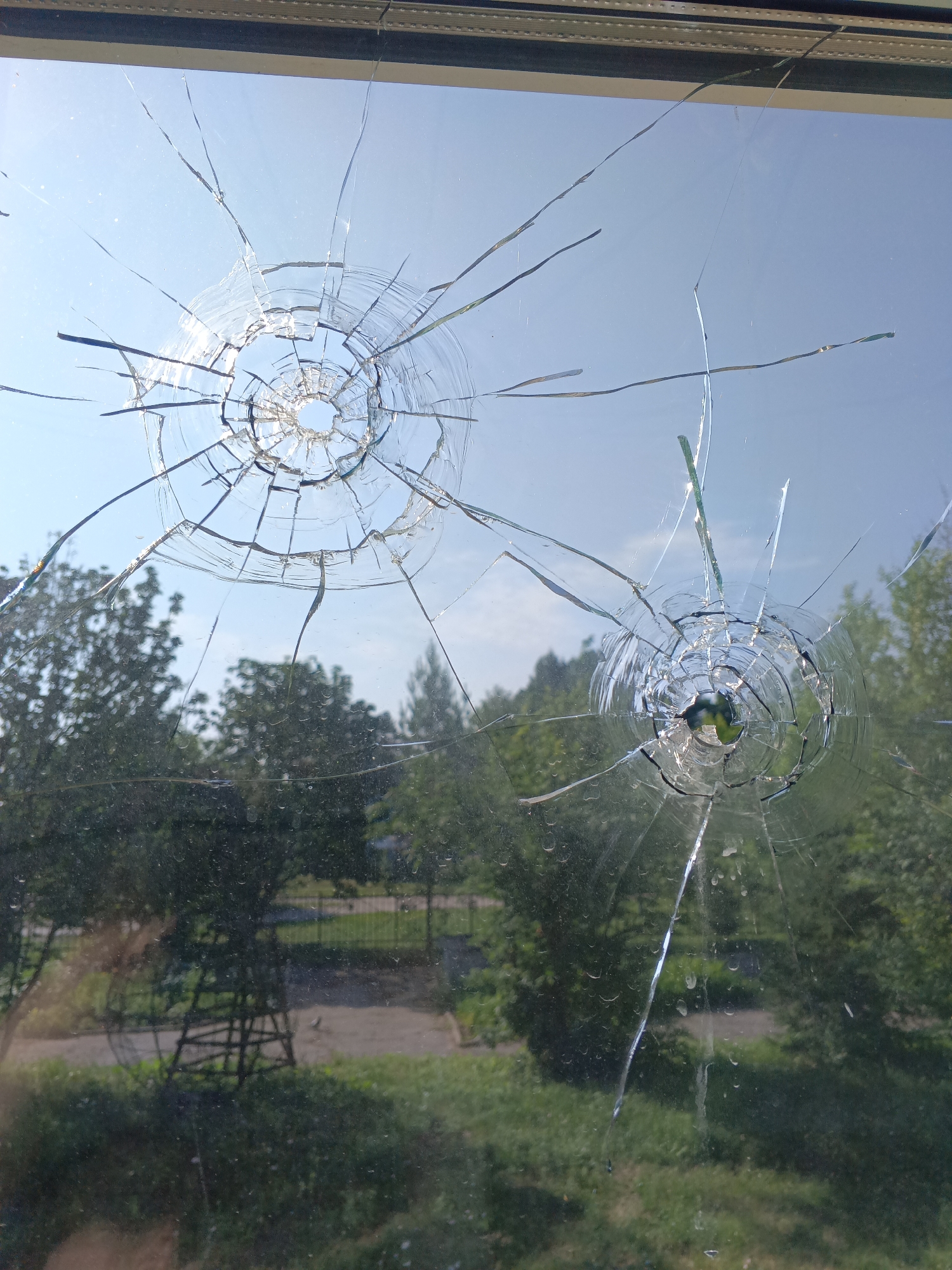 Park area scenes: sculpture, construction, umbrella bench, bullet-holed window