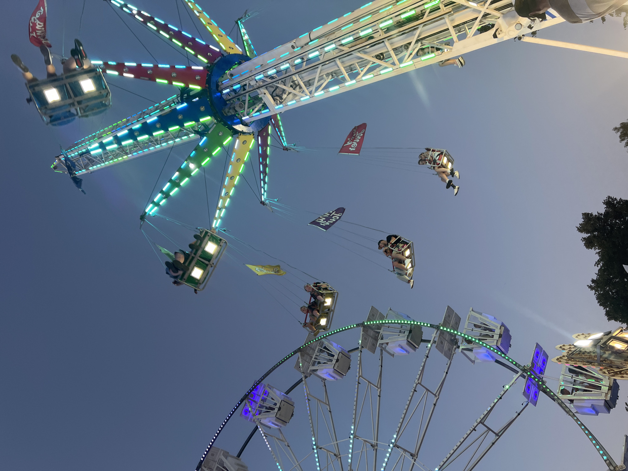 Fairground rides light up a summer evening in Tychy