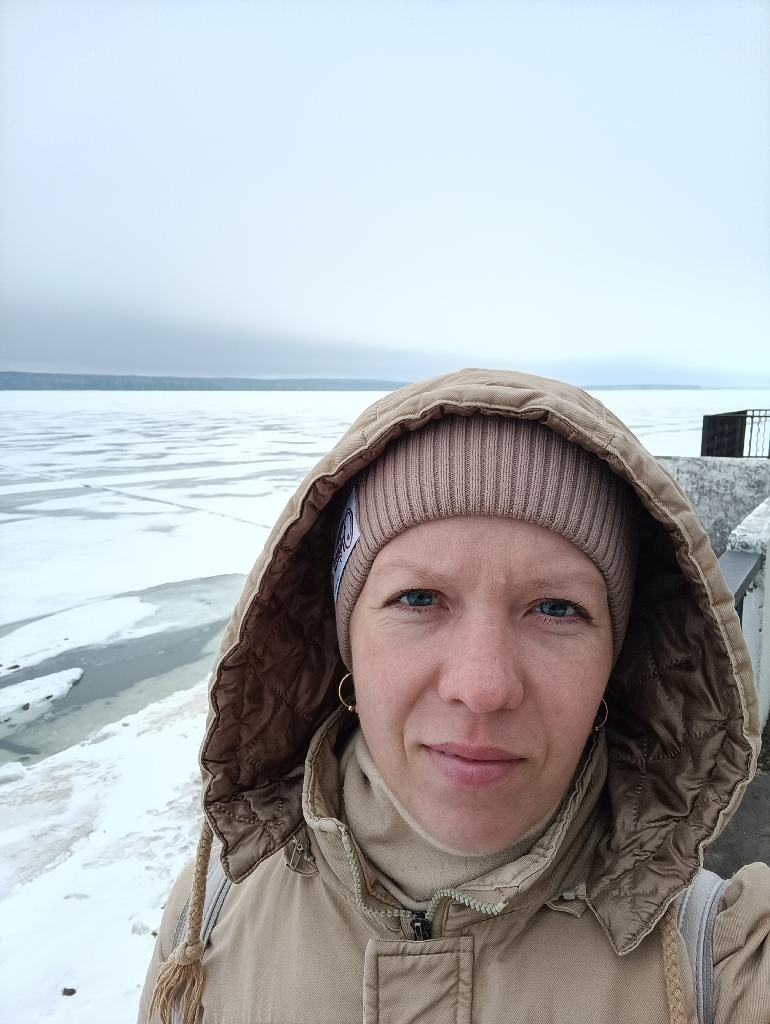 Woman takes selfie near frozen water in Chaikovsky, Russia