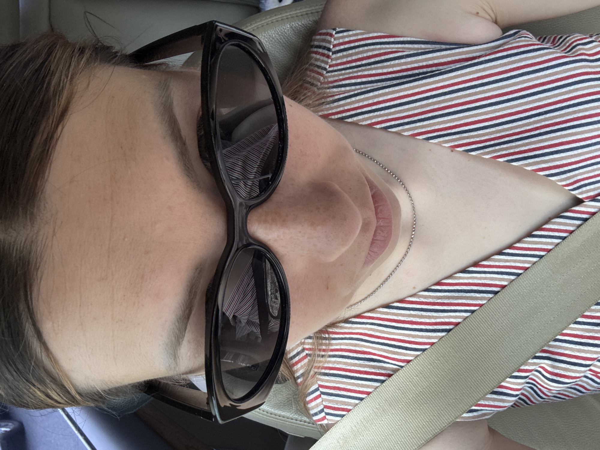 Woman in striped dress photographed in car, Balashikha