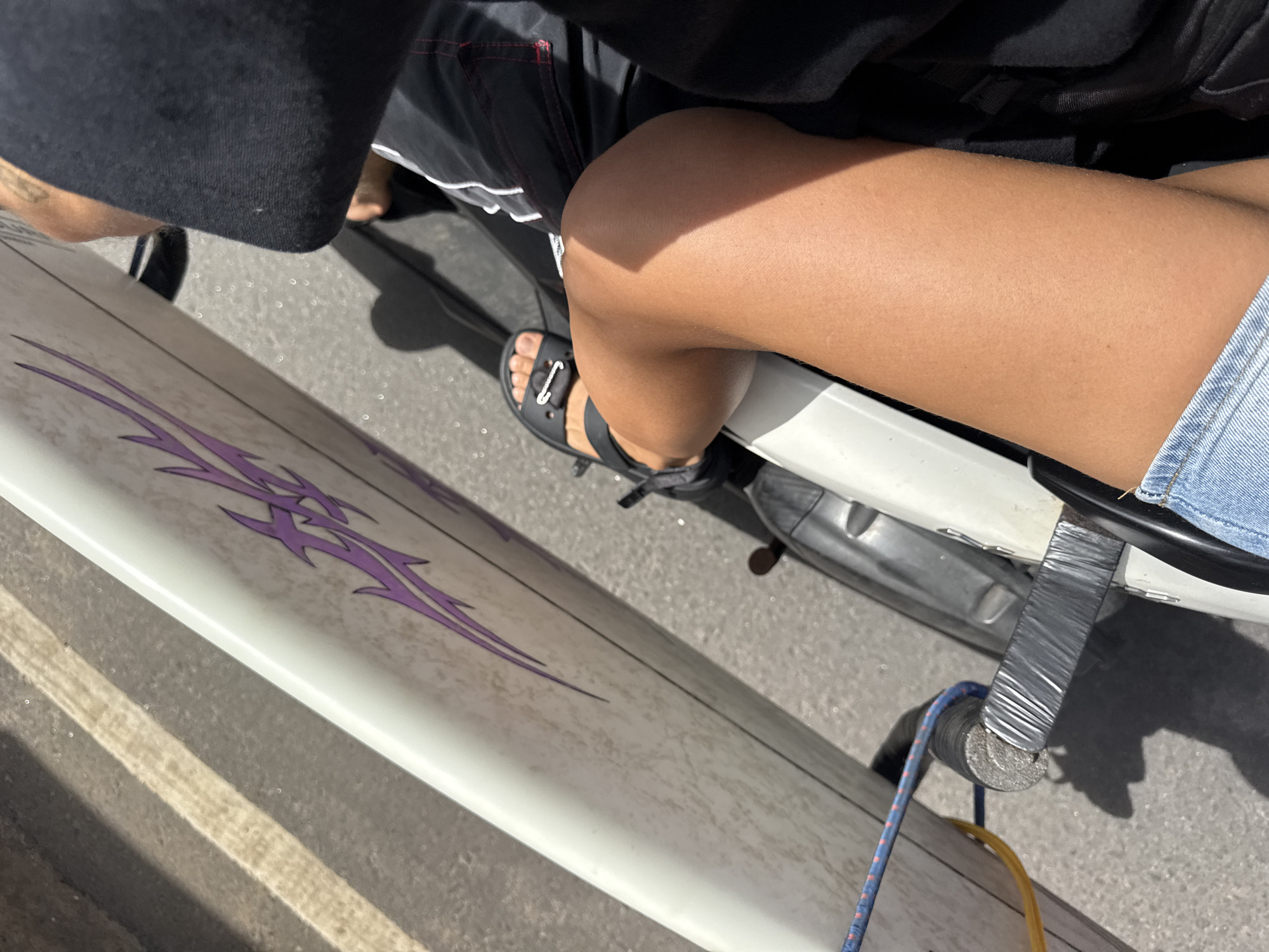 Surfboard strapped to a scooter, ready to hit the Sri Lanka coast