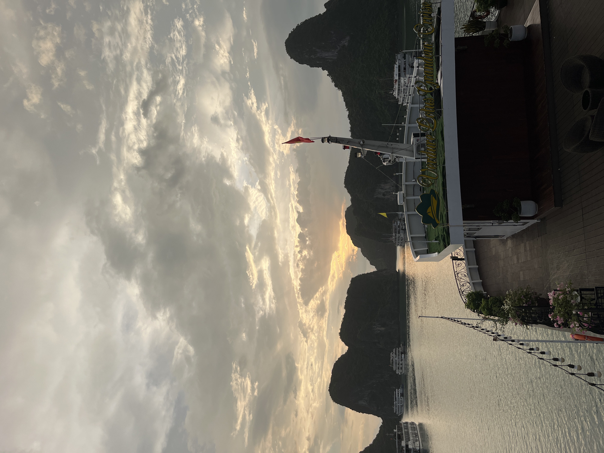 Ha Long Bay karsts and cruise boats at golden hour