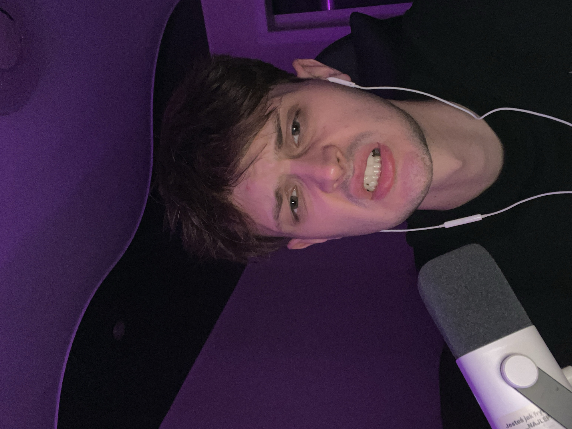Late-night gaming session with purple LEDs, selfies, and a cat