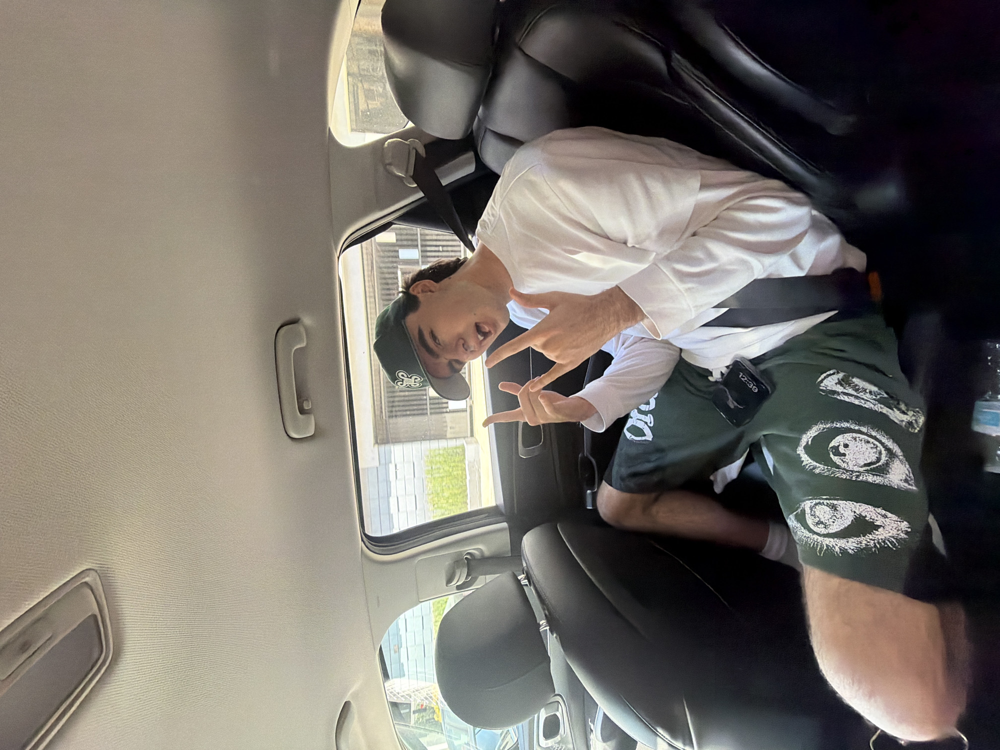 Man makes peace signs from car backseat in West Hollywood