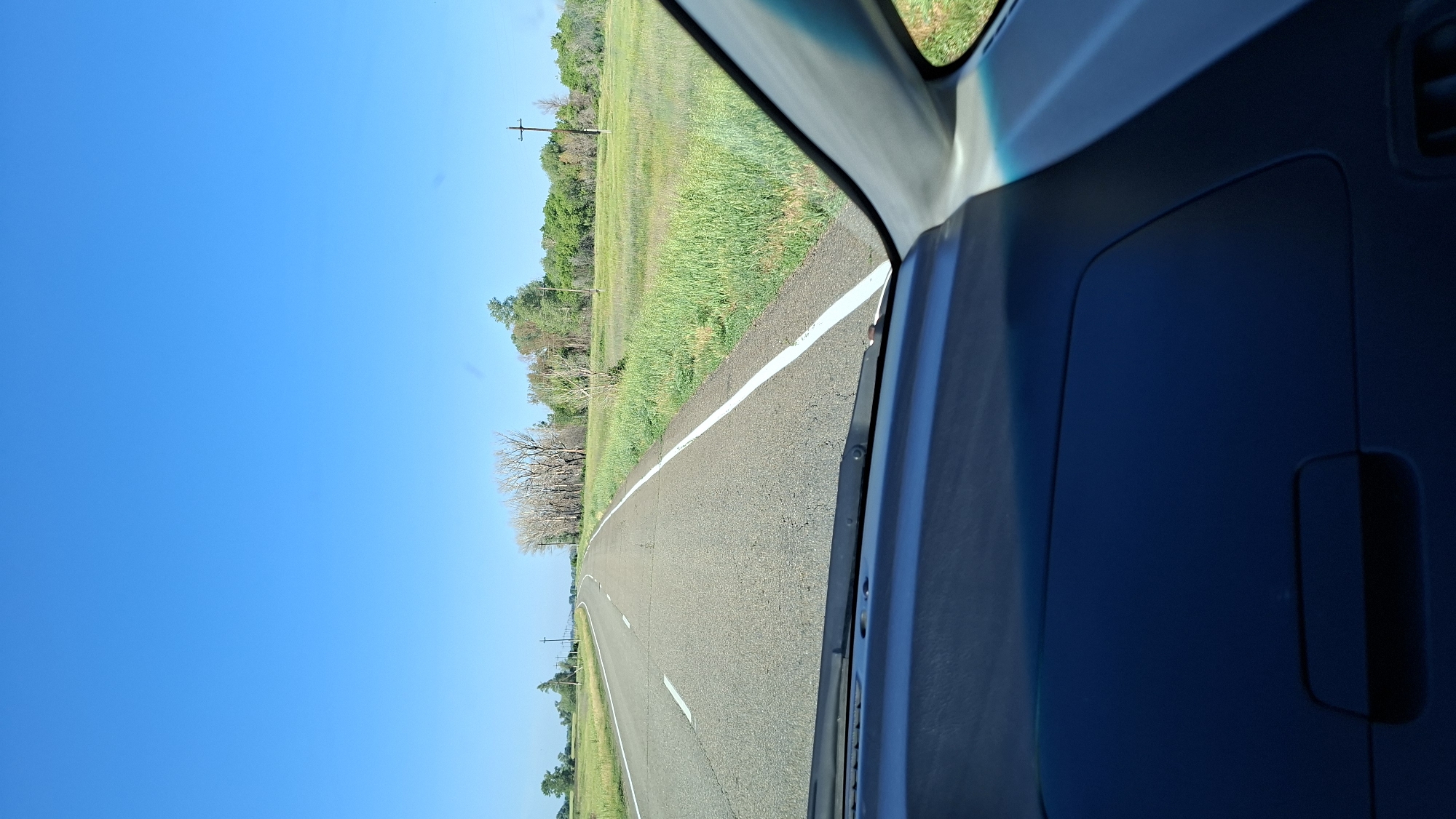 Woman drives through rural countryside during early morning hours