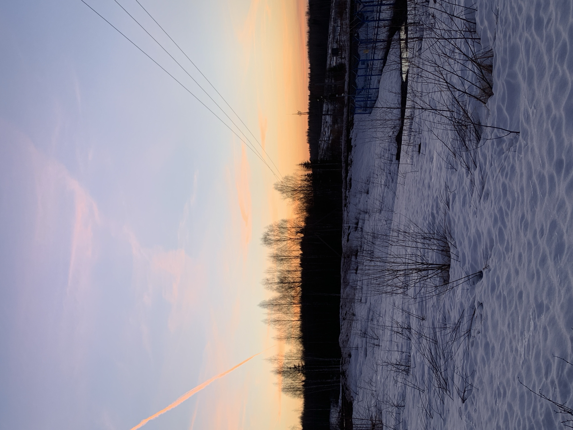Winter sunset over snowy Russian oil fields