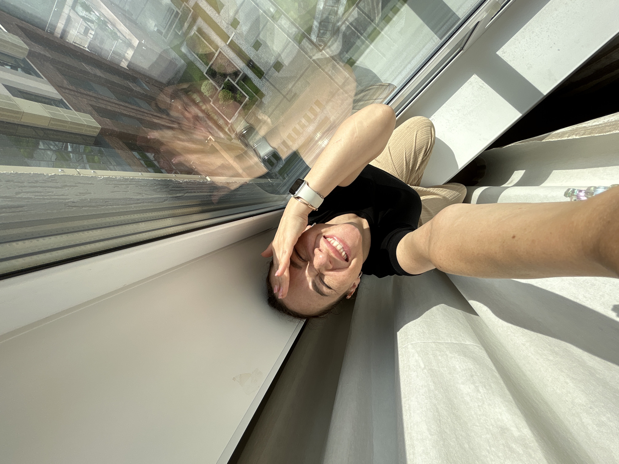 Woman takes playful window selfies in Yekaterinburg building