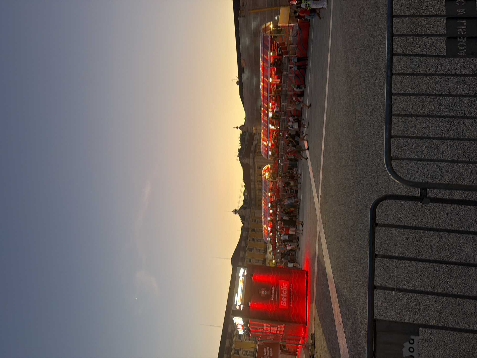 Lisbon's Praça do Comércio buzzes at dusk during football fan event