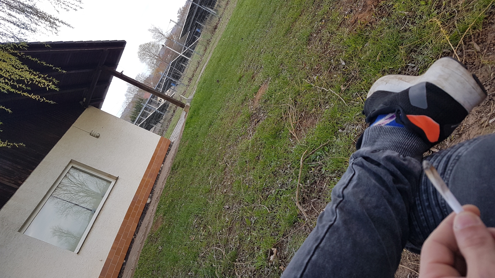 Person photographed outdoors in Heinebach holding lit object