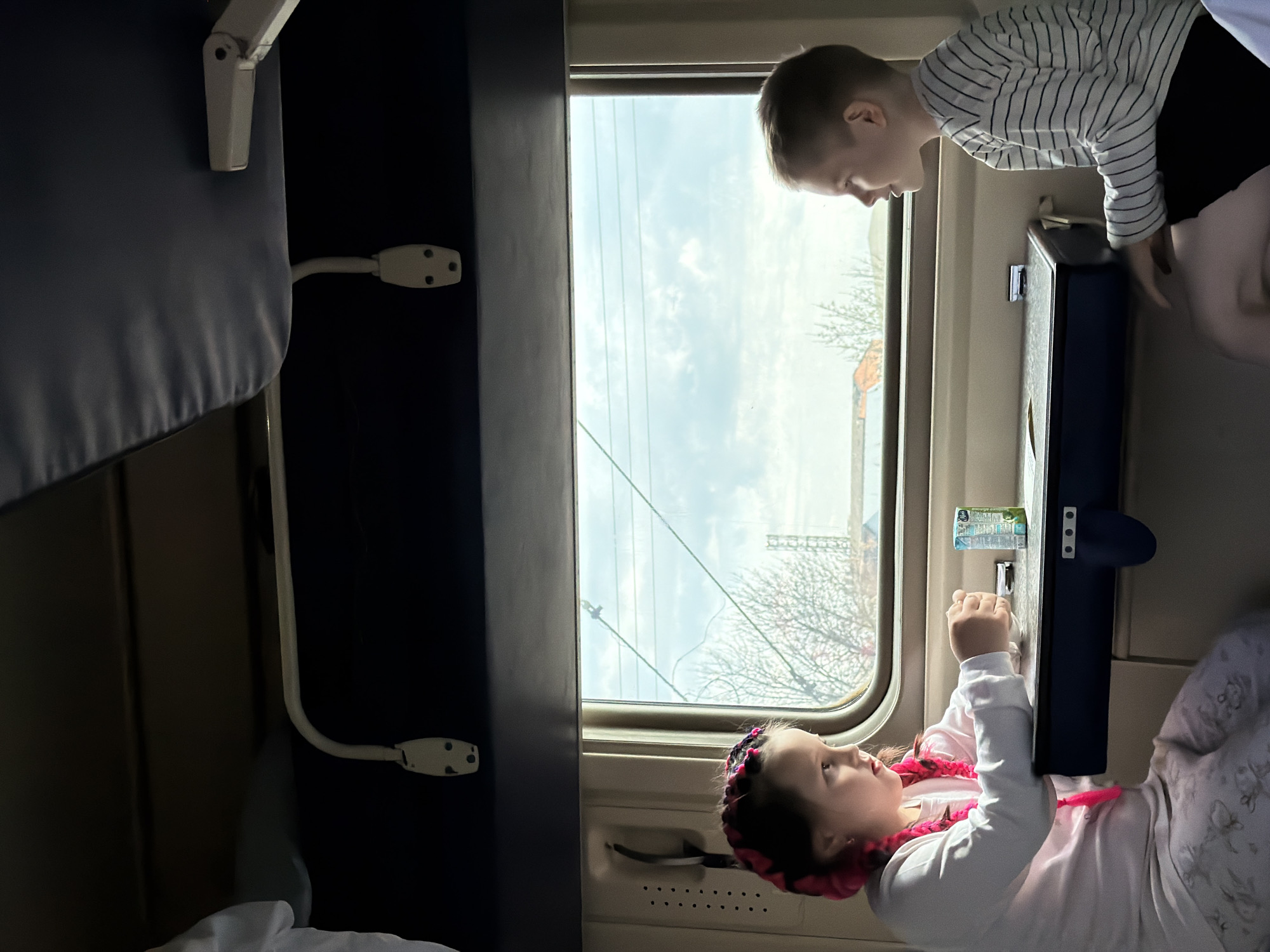 Children travel by train, woman rests in Medvyodovskaya
