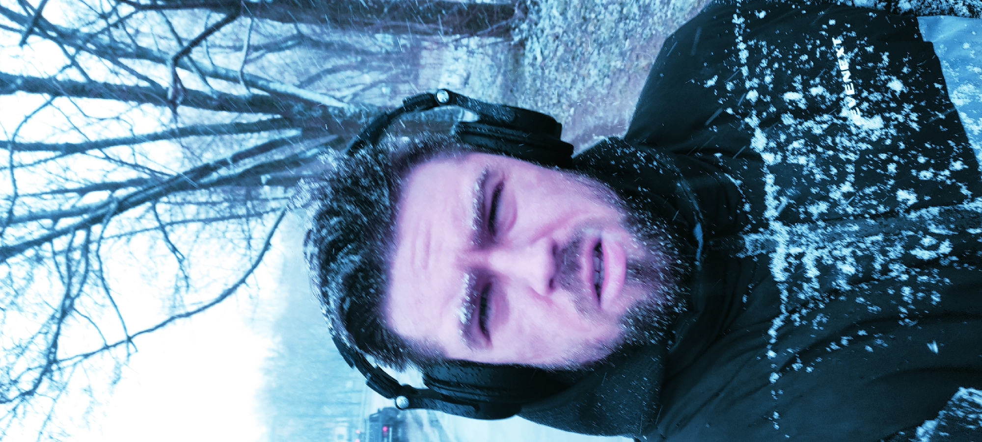 Man photographed in snowfall wearing headphones in Fryazino