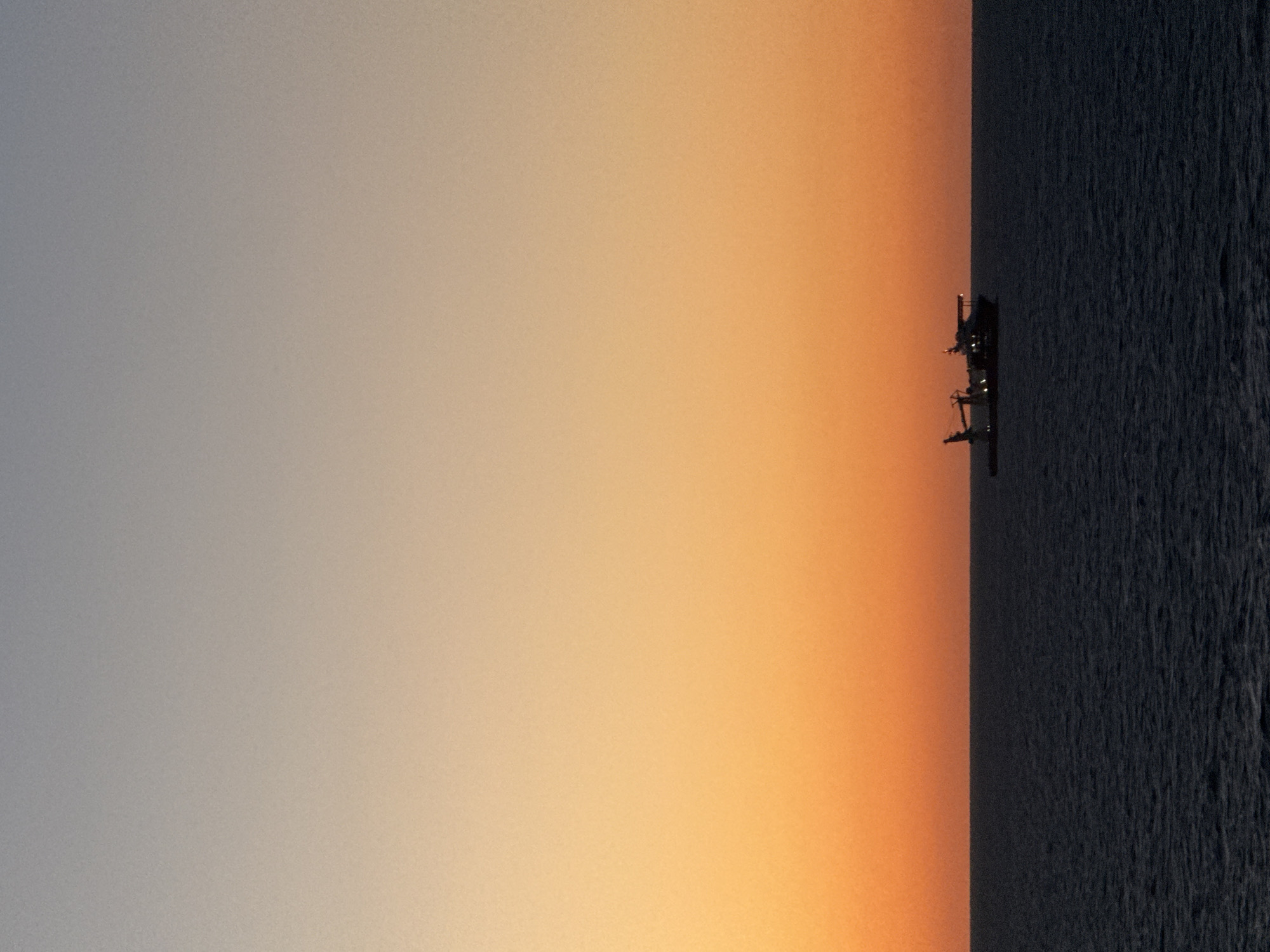 Gulf sunset documented with birds, oil rig visible