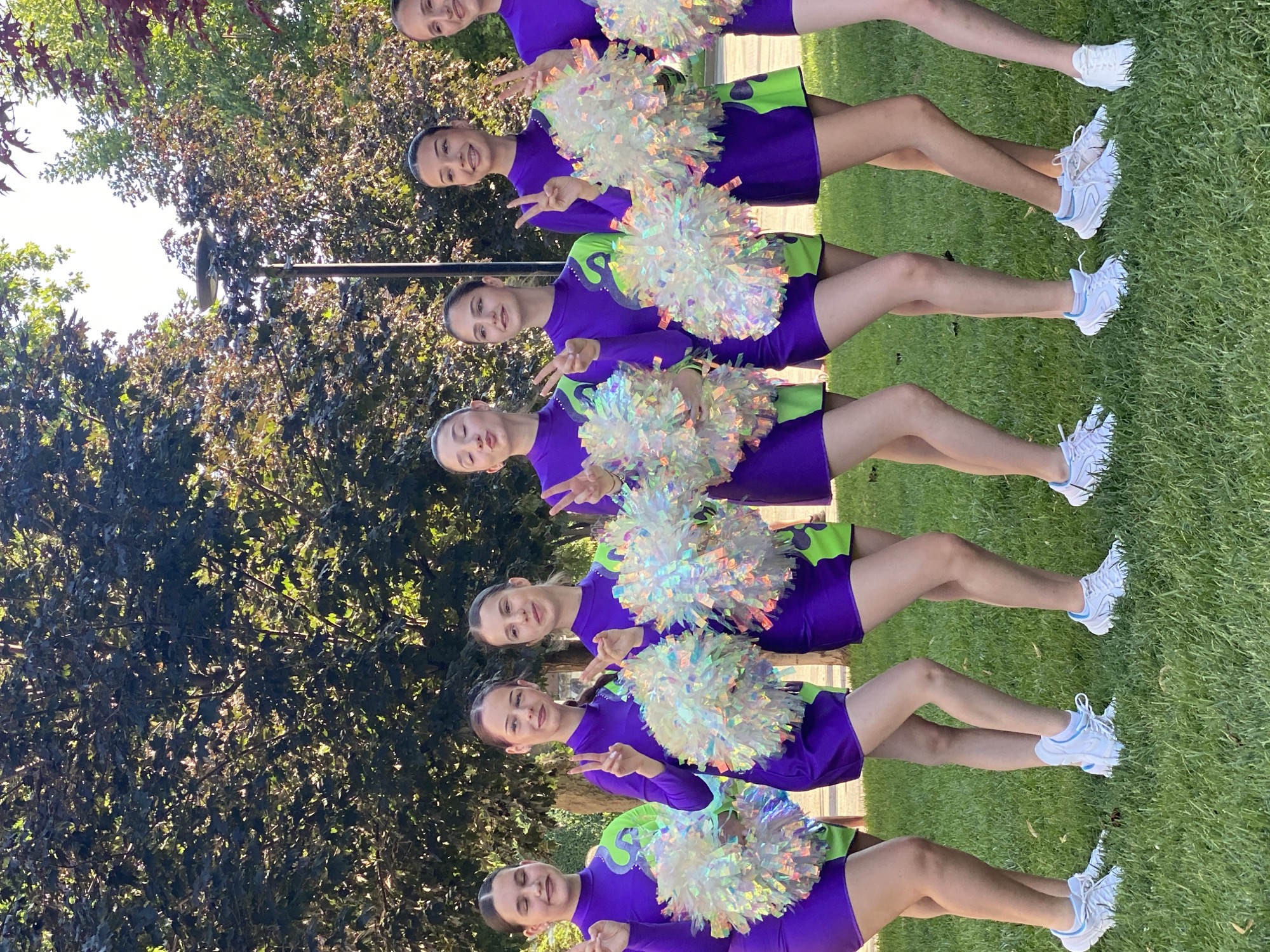 Cheerleading squad poses with pom-poms on Pleven lawn
