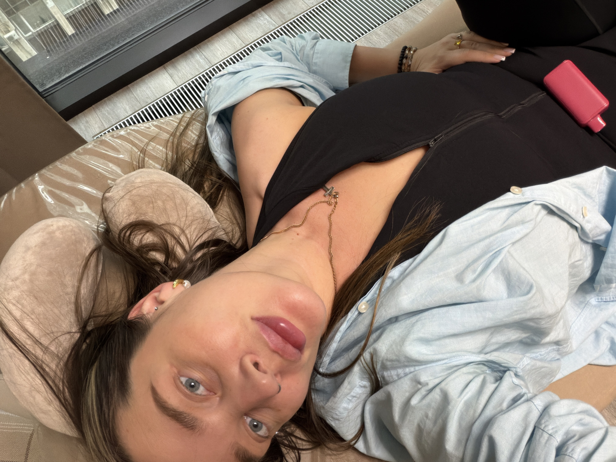 Woman rests on pillow in Moscow wearing cross necklace