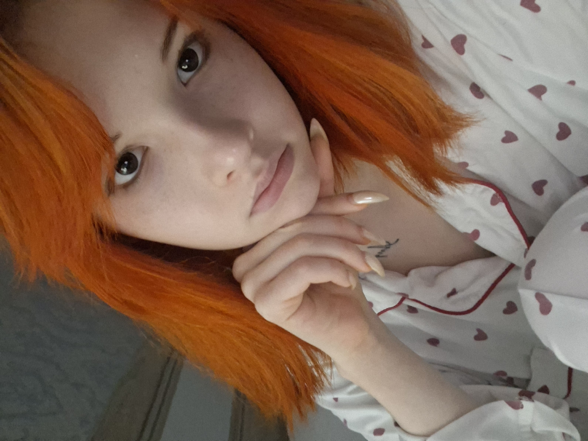 Woman takes selfies in heart-patterned pajamas in Chaikovsky, Russia
